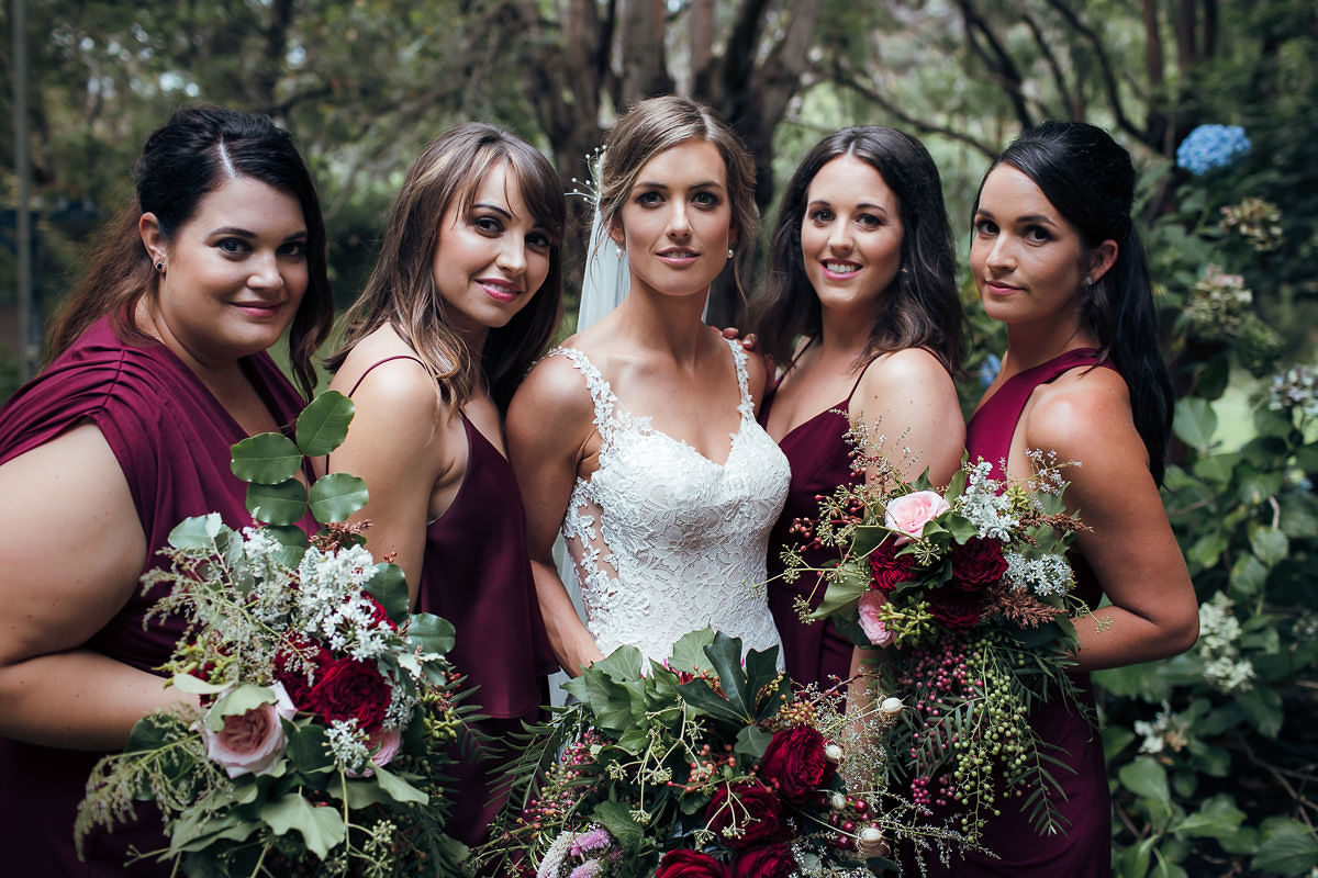bride and brides maids posing with flowers beautiful