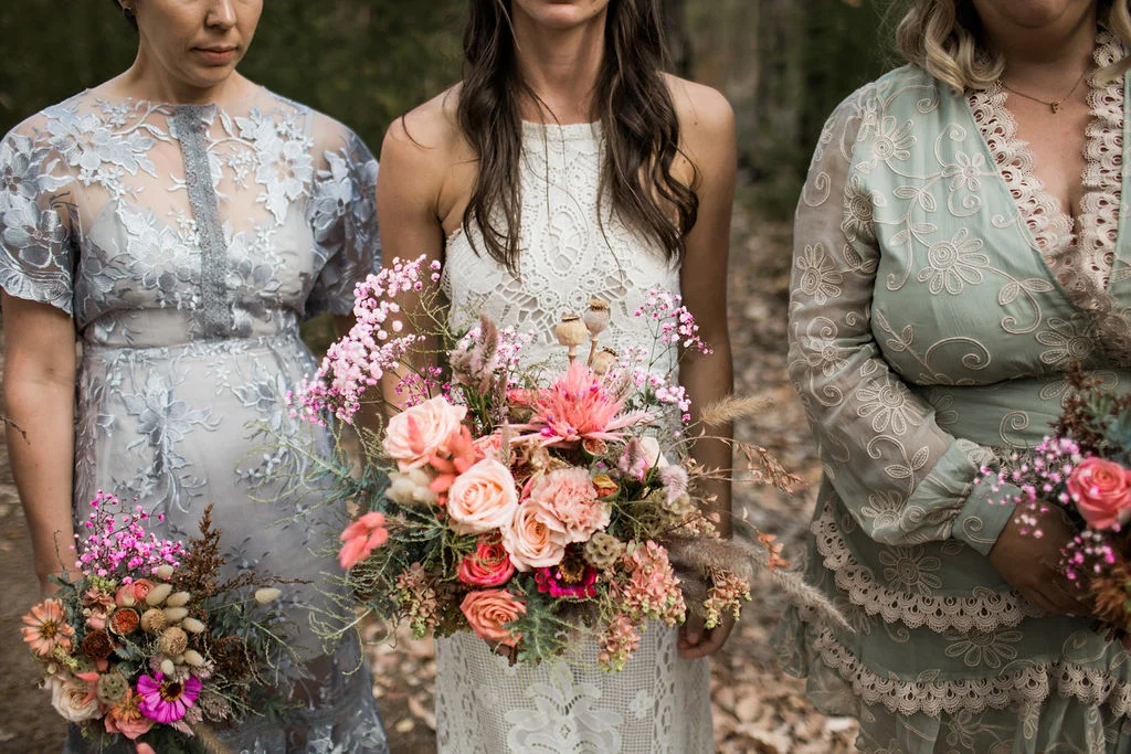 bride and brides maids walking bouquet of flowers