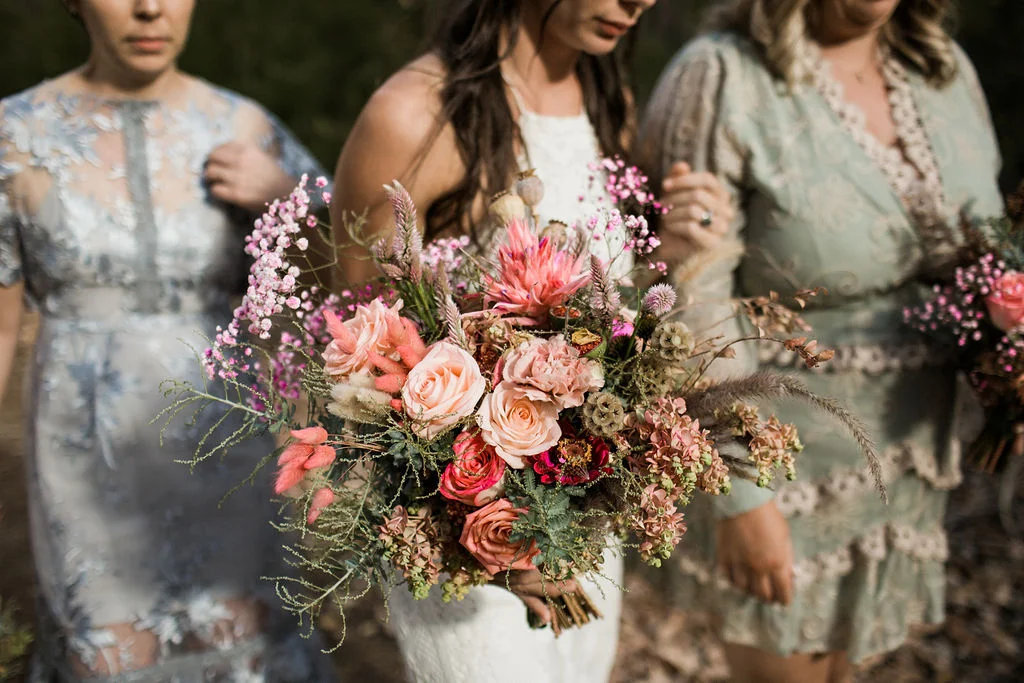 bride and brides maids walking bouquet of flowers