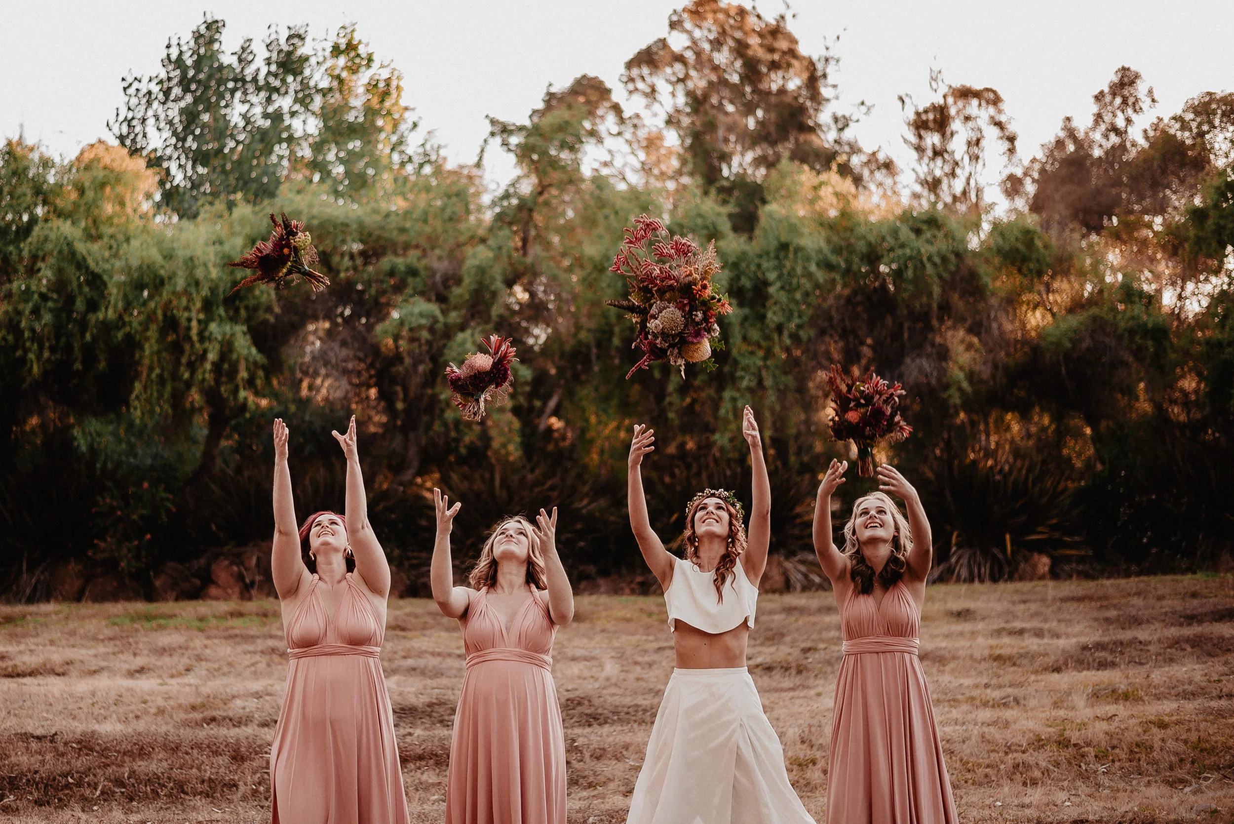 brides groom throwing flowers in the air after wedding