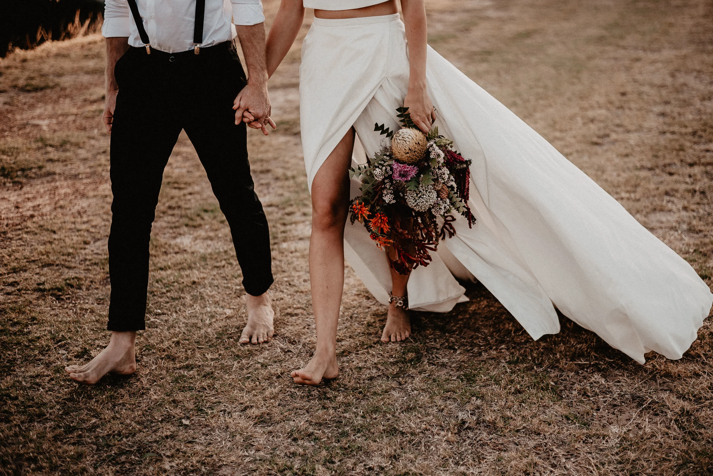 bride and bride groom holding hands walking