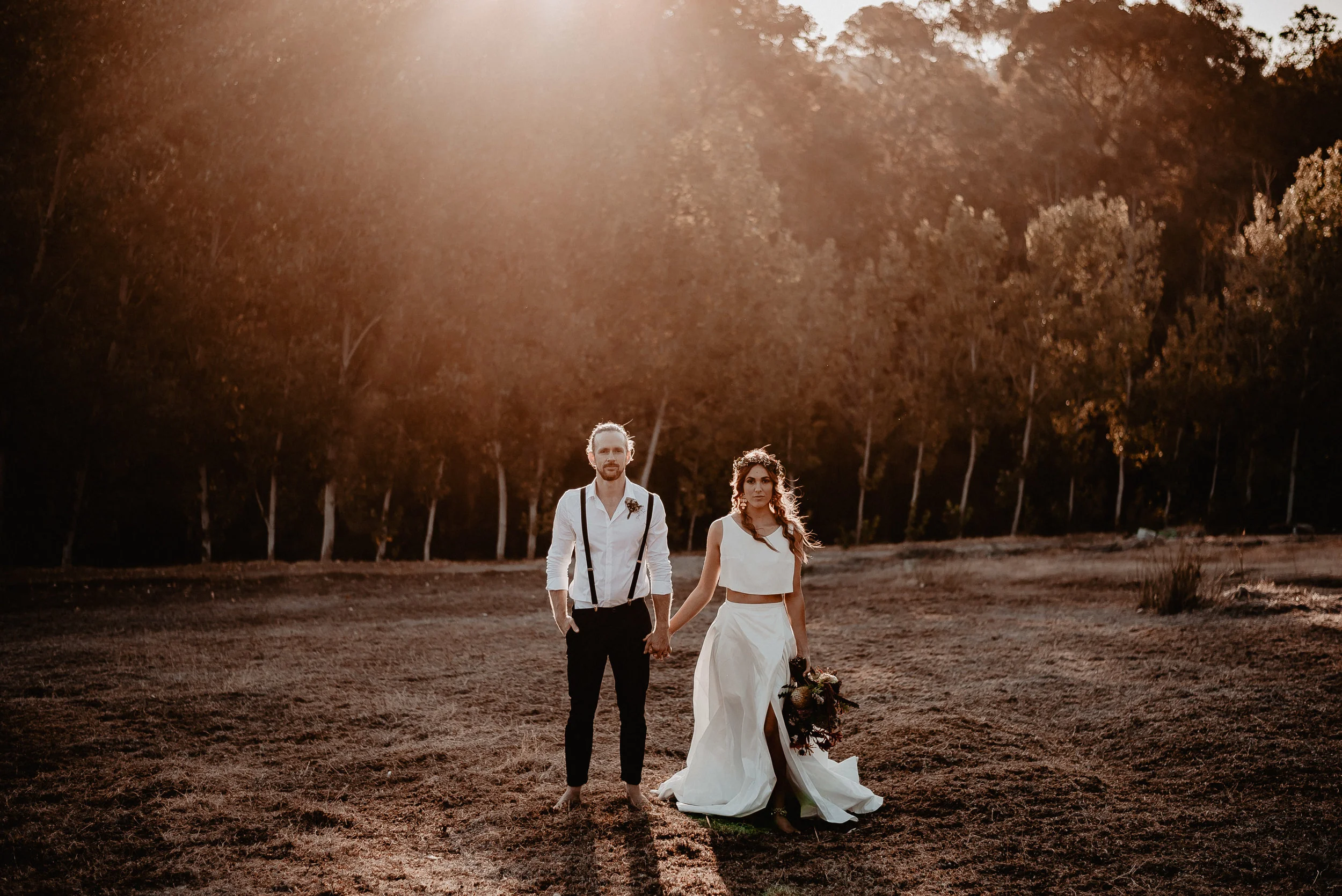 bride and bride groom holding hands walking holding hands