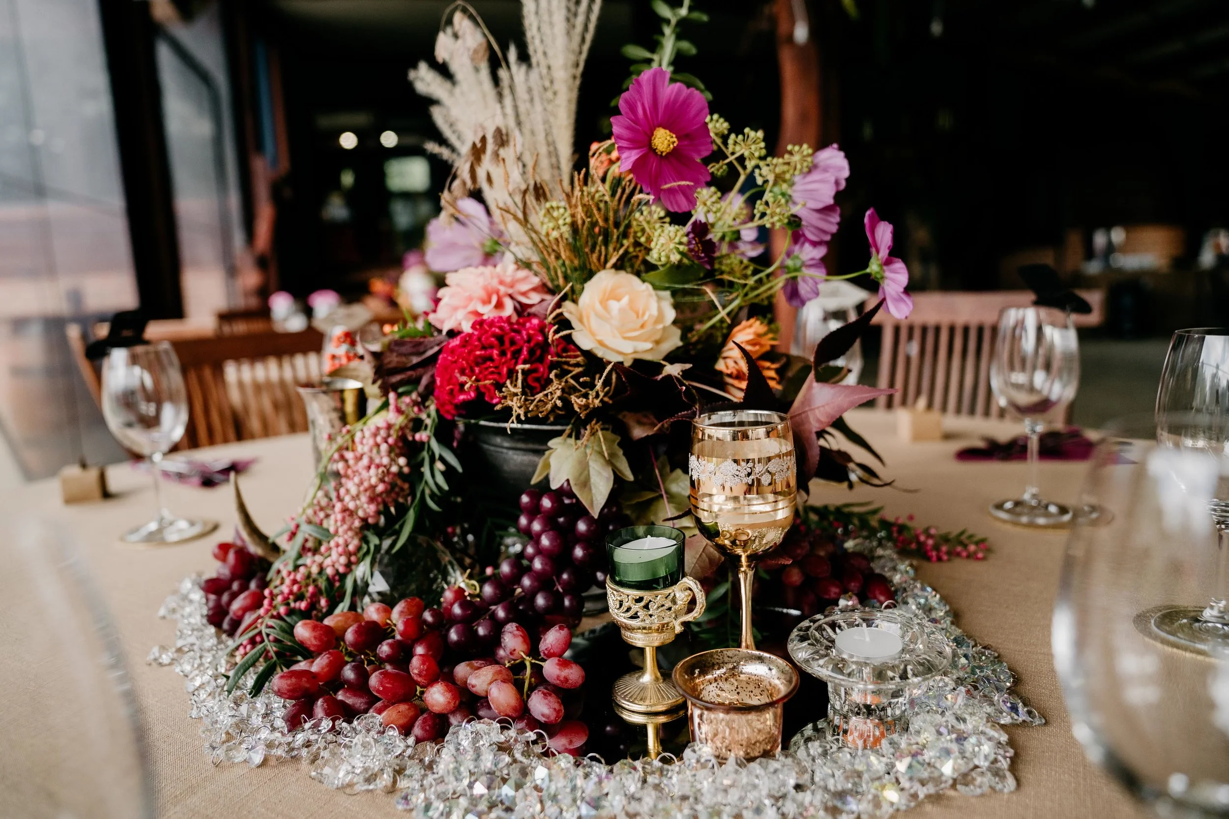 wedding centrepiece with grapes and crystal and candleholders