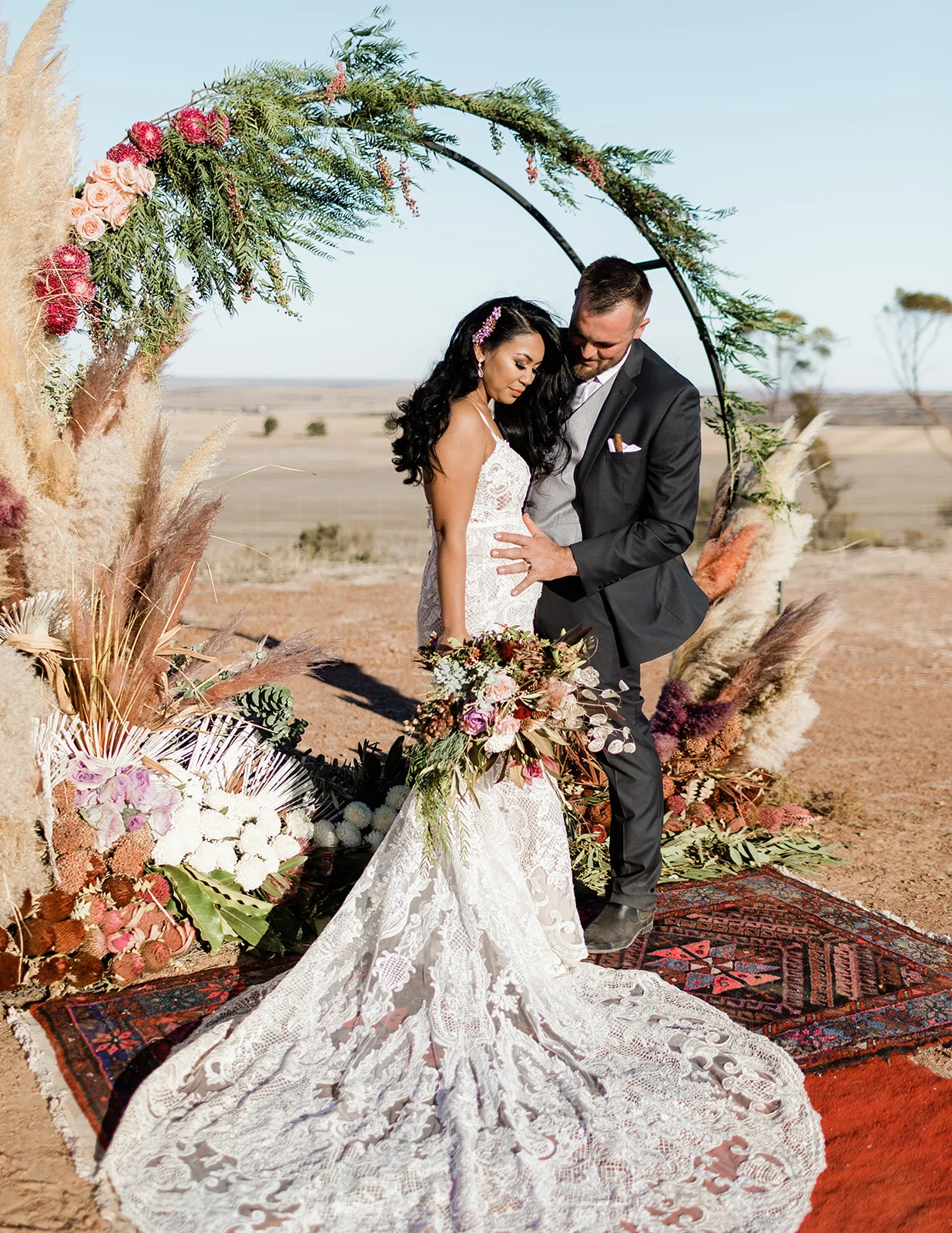 bride with bouquet of seasonal wedding flowers standing at the altar with bride groom
