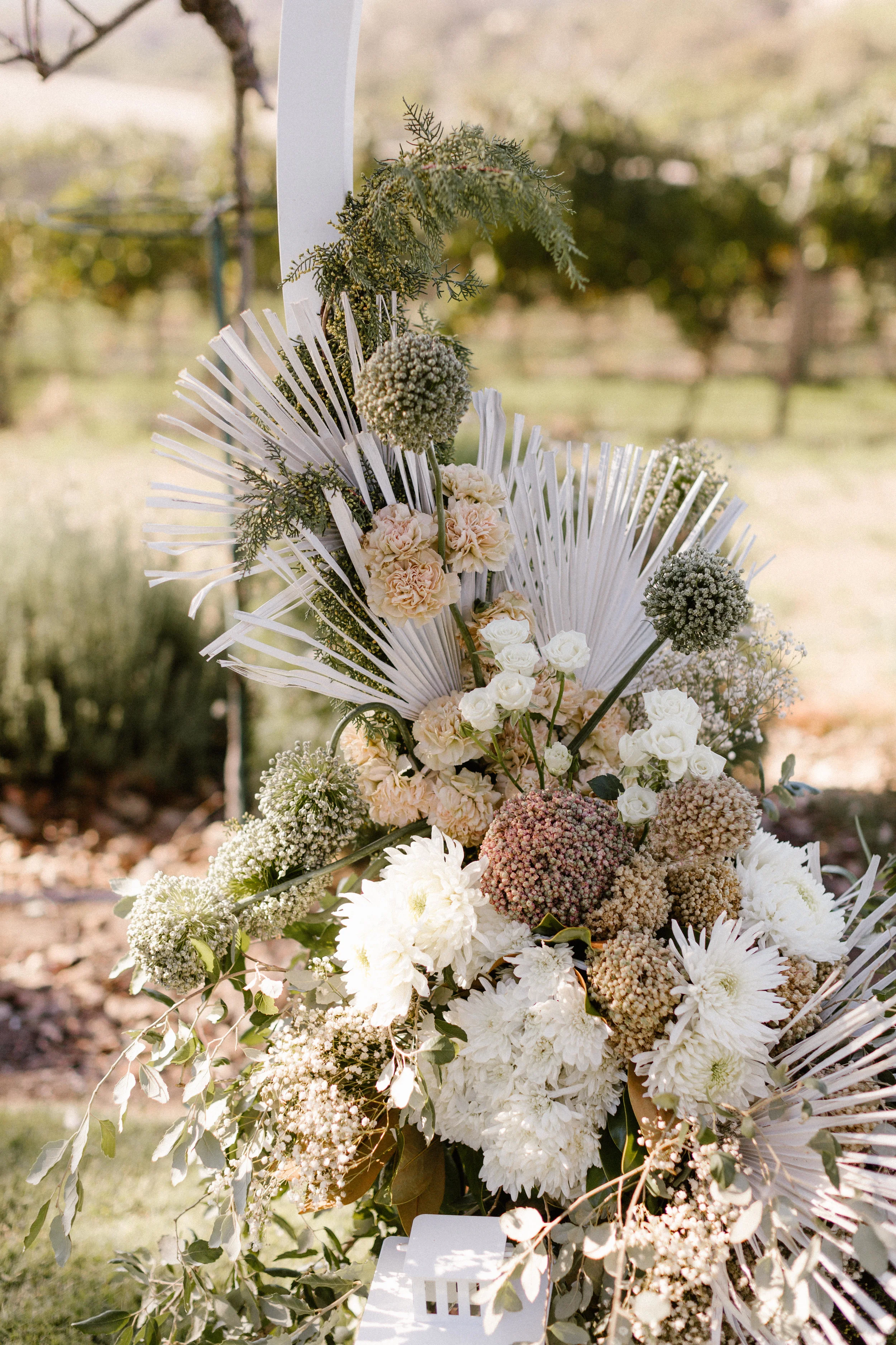  wedding flowers on a hanging from a wedding altar arch  