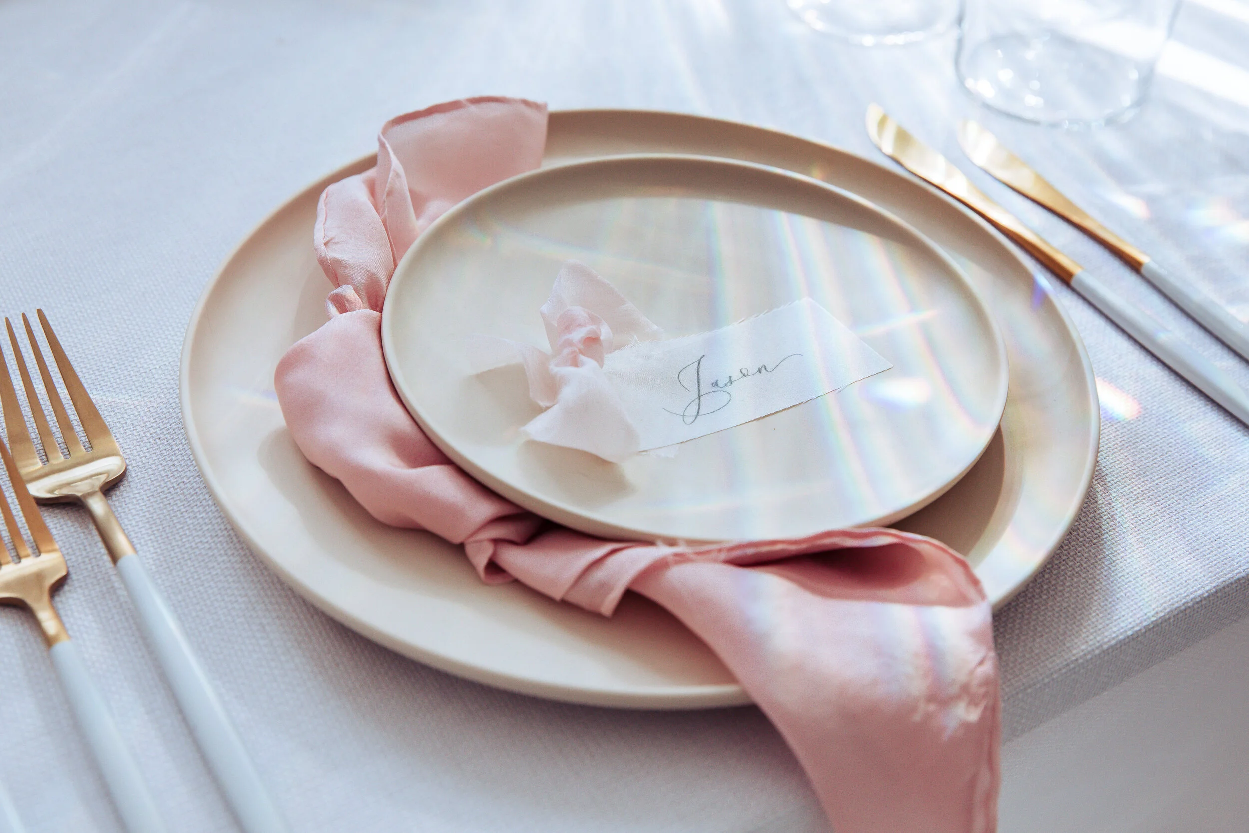 white terracotta plate with bush pink silk napkin and gold cutlery