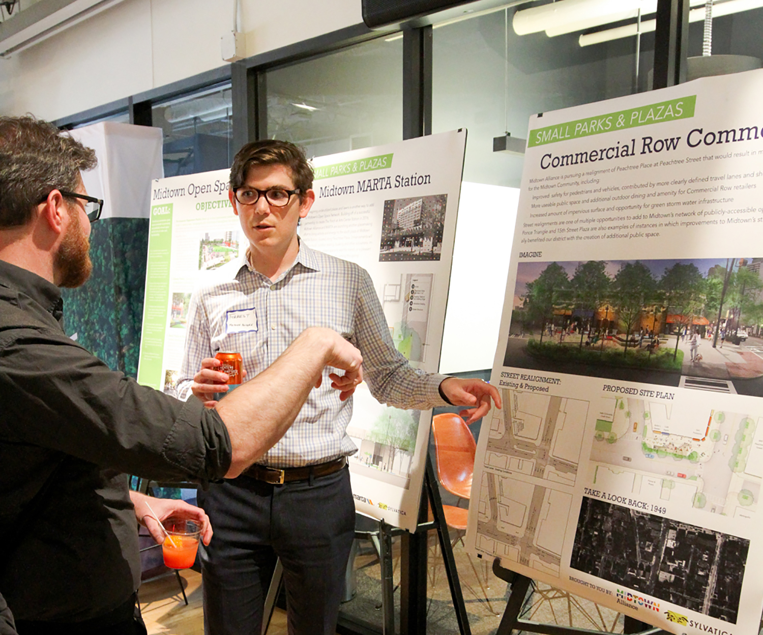 Midtown Alliance project manager for transportation Forrest Rose engages with a Midtown community member at a public informational meeting.