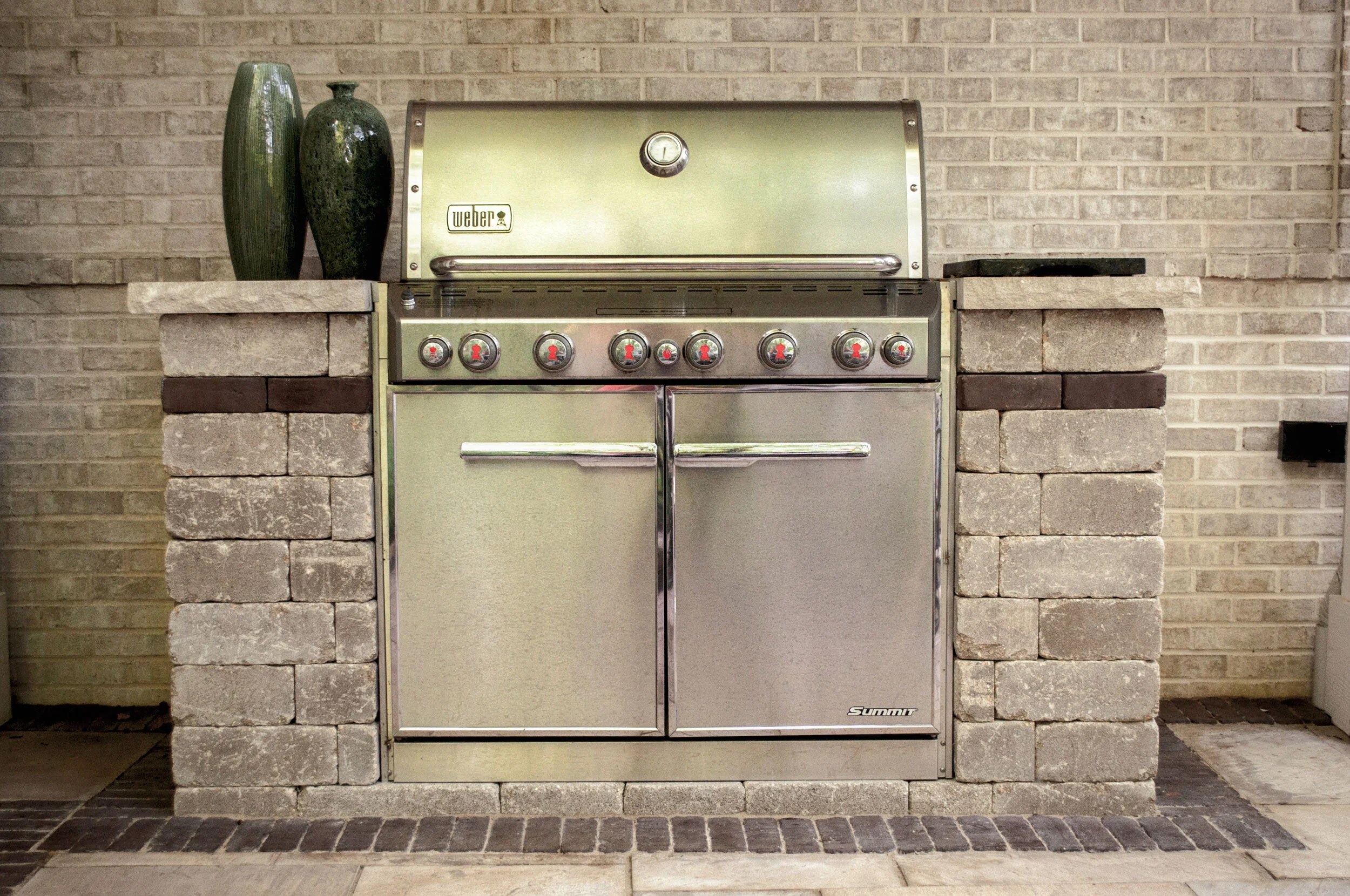 Tumbled blocks and limestone caps create a simple and beautiful grill island-designed by Sundown Gardens.jpg