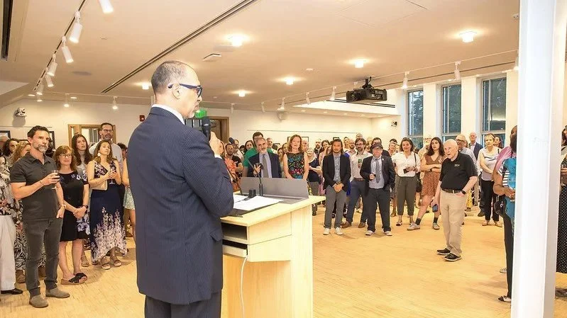 Board President Robert Marchman speaks to staff and supporters