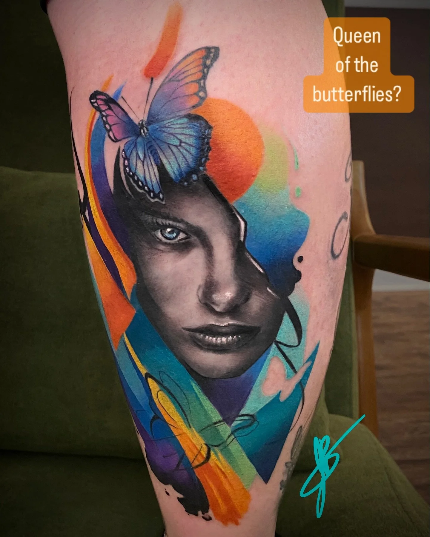 What title would you give this tattoo? Black and grey portrait with graphic design elements in full color..