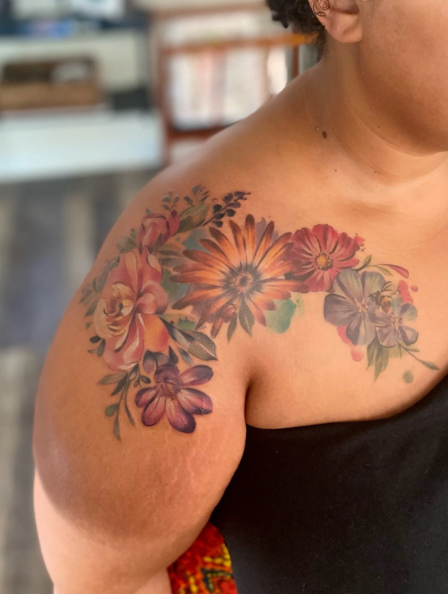Fresh blooms on skin 🌸✨
This shoulder piece was all about movement, color, and flow&mdash;bringing together a bouquet of flowers in a watercolor-inspired style. I love how the colors play across the shoulder and wrap into the chest and arm, making i