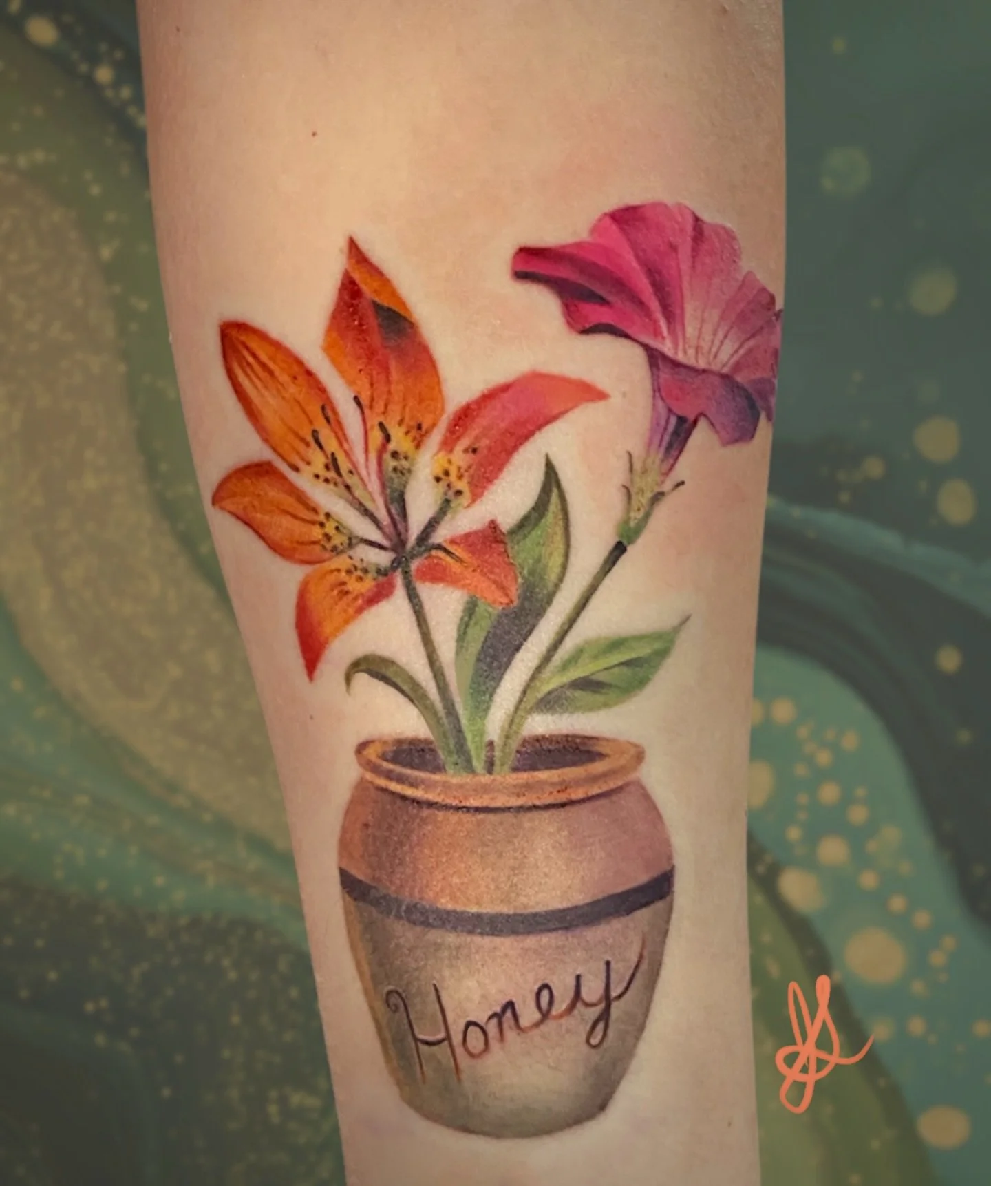 A gentle memorial design of an orange lily and pink petunia arranged in a classic honey pot inspired by those from of Winnie the Pooh. Together, the flowers rest in the humble honey pot like a quiet keepsake&mdash;an image of warmth, nostalgia, and a
