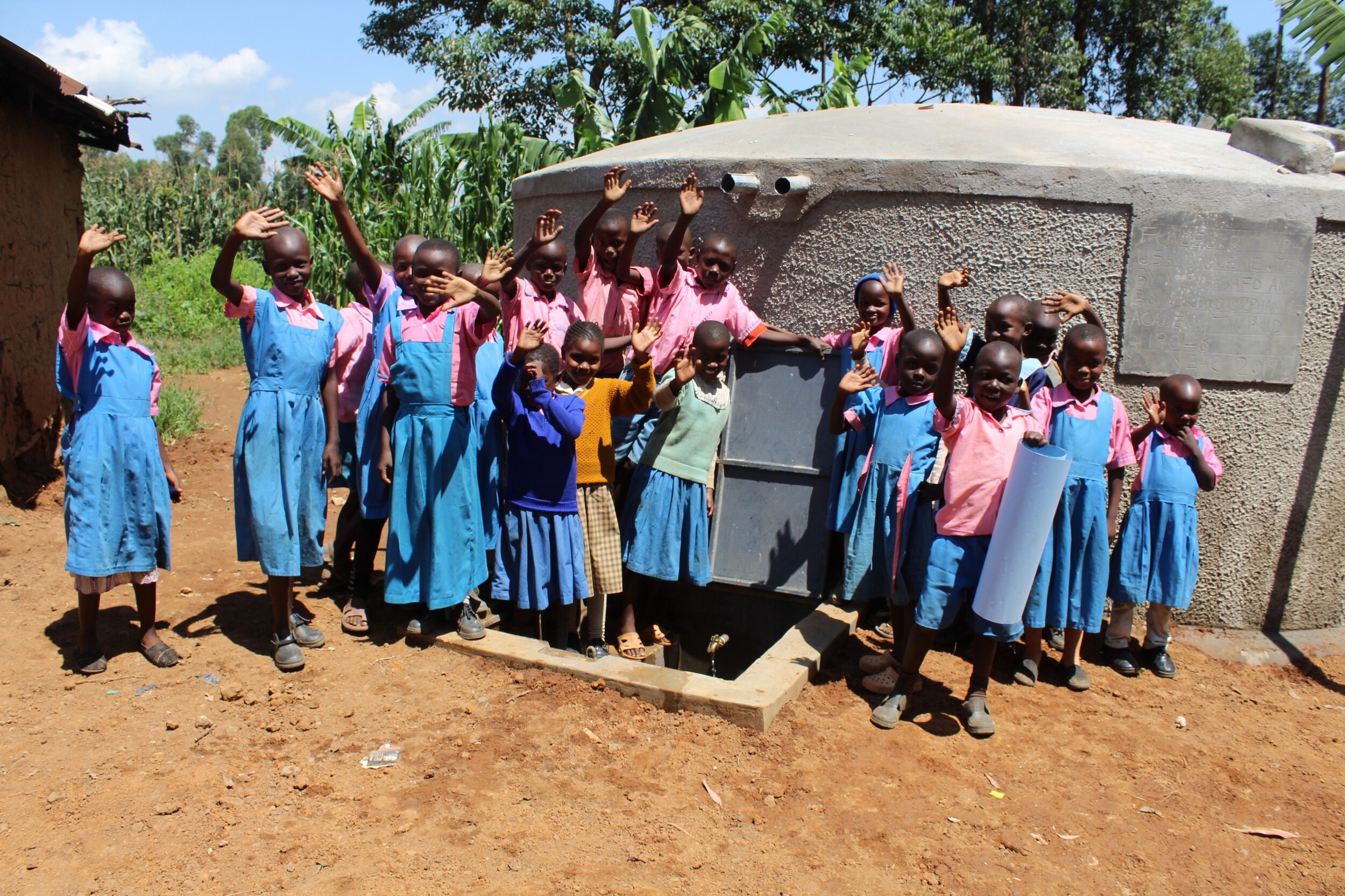 31 kenya19046 Students celebrate the rain tank.JPG
