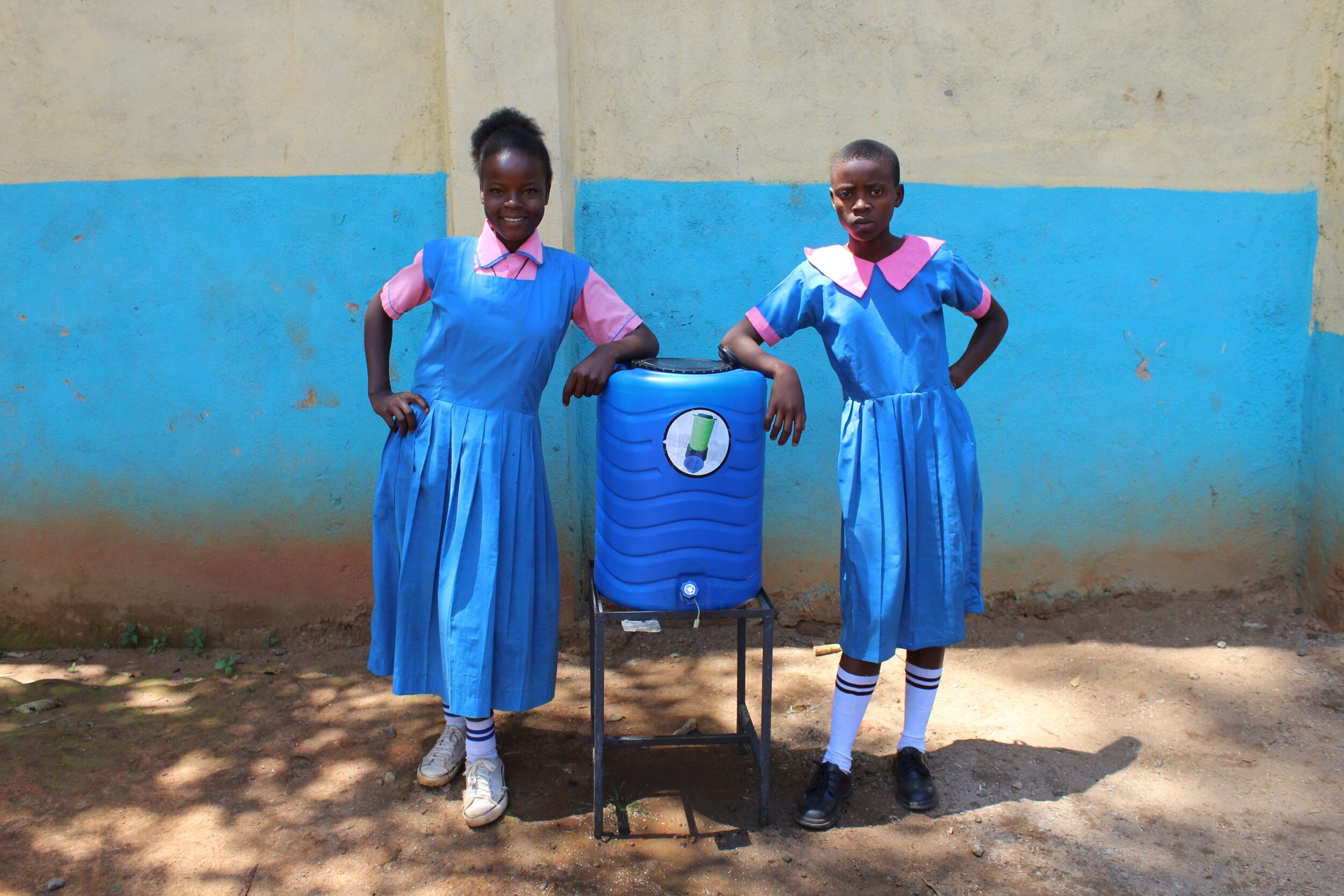 26 kenya19046 Girls with handwashing station (1).JPG