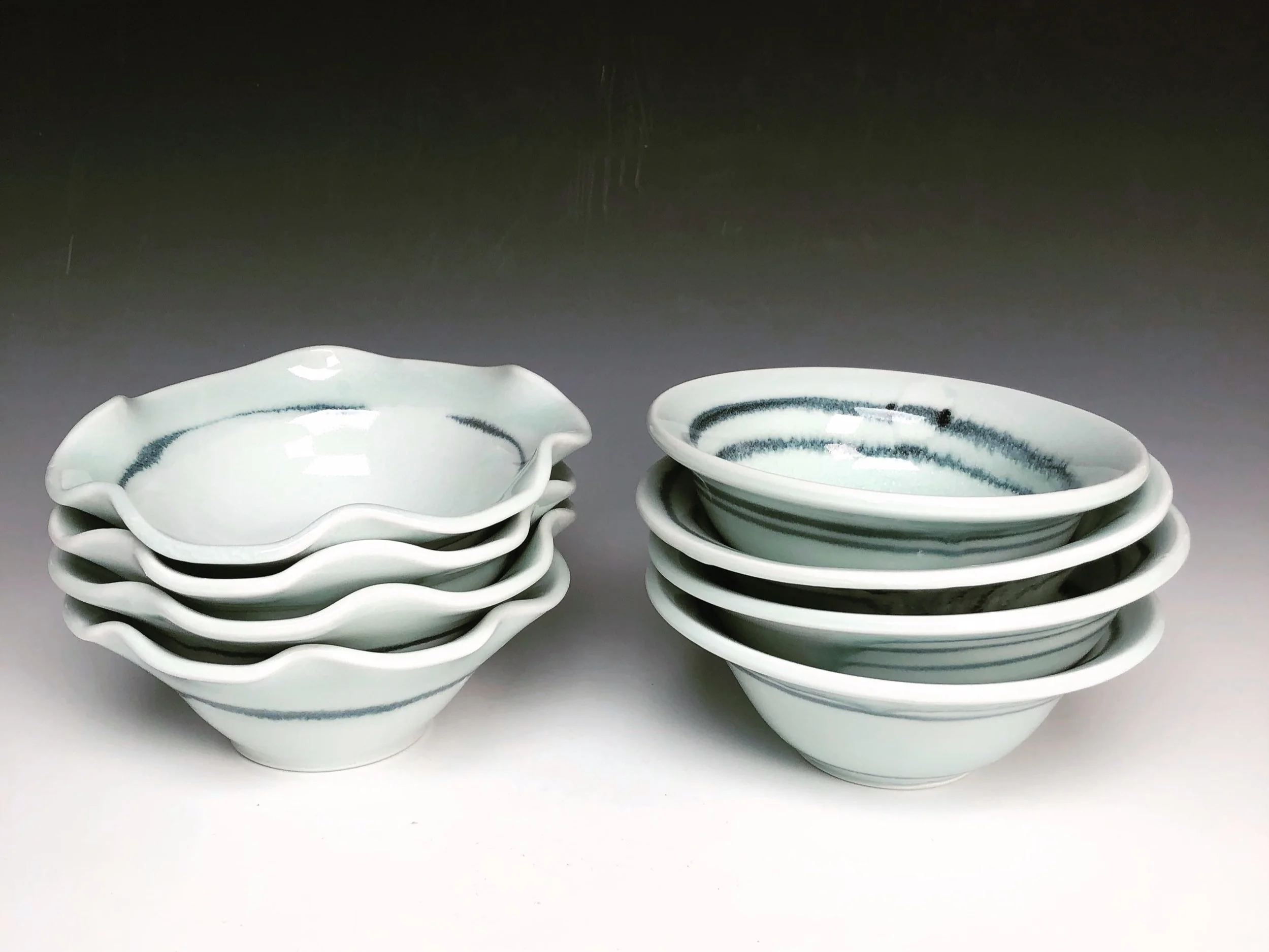 5-6 inch dessert bowls or side dishes. A kitchen must! Perfect for just about everything from fresh fruit, ice cream, olives, nuts, rice…. any and all side dishes you can imagine! White with a celadon green rim to enhance the movement of deep blue black line.