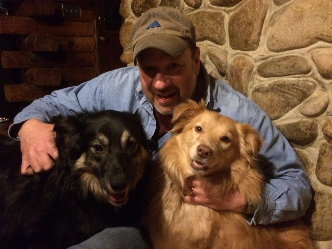 John Morano at home with his rescued Australian Shepherds