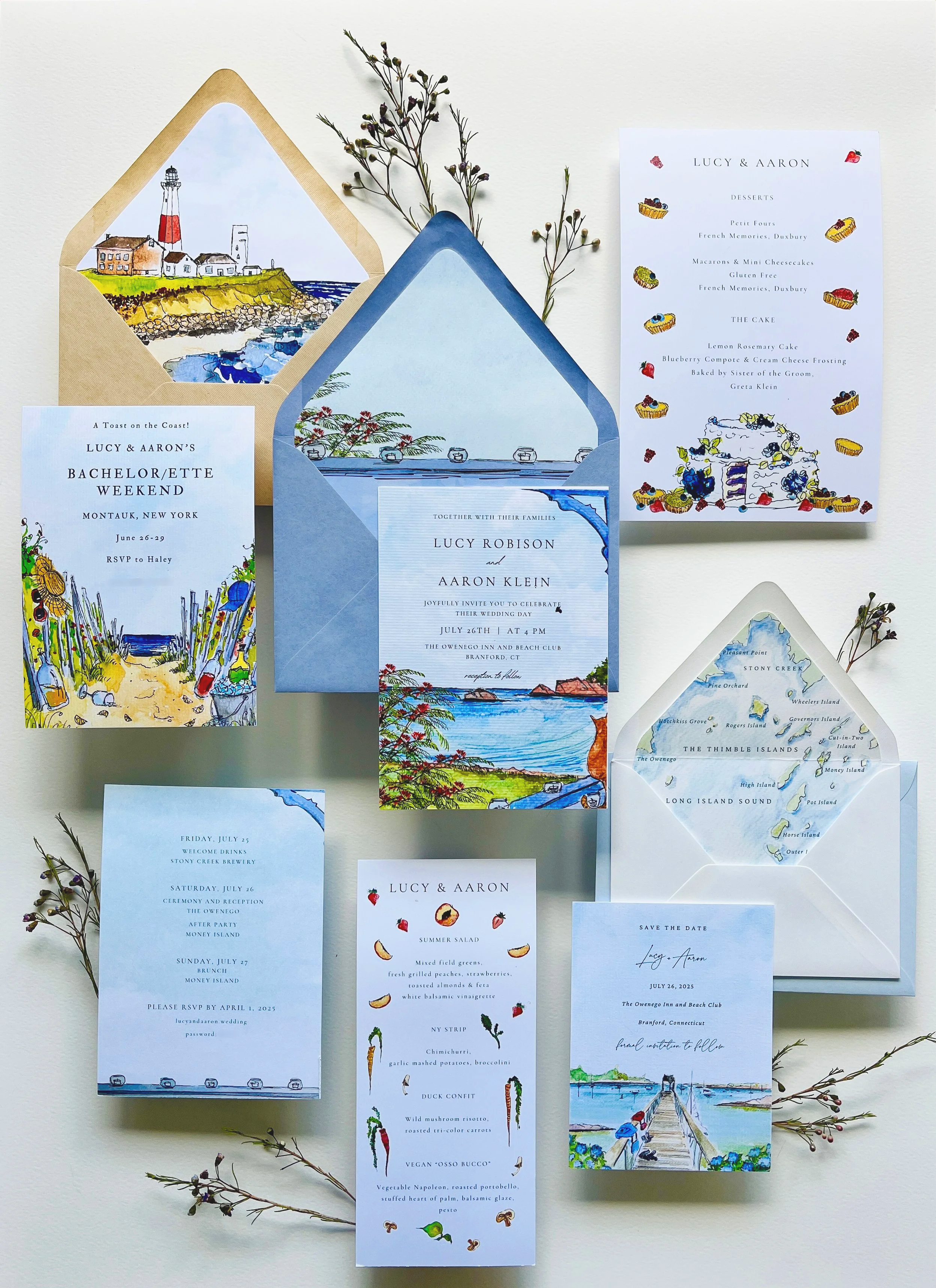 Set of illustrated wedding invitations, RSVP cards, menu, and save-the-date cards featuring coastal scenery and watercolor illustrations of beaches, lighthouses, and islands, arranged with sprigs of greenery.