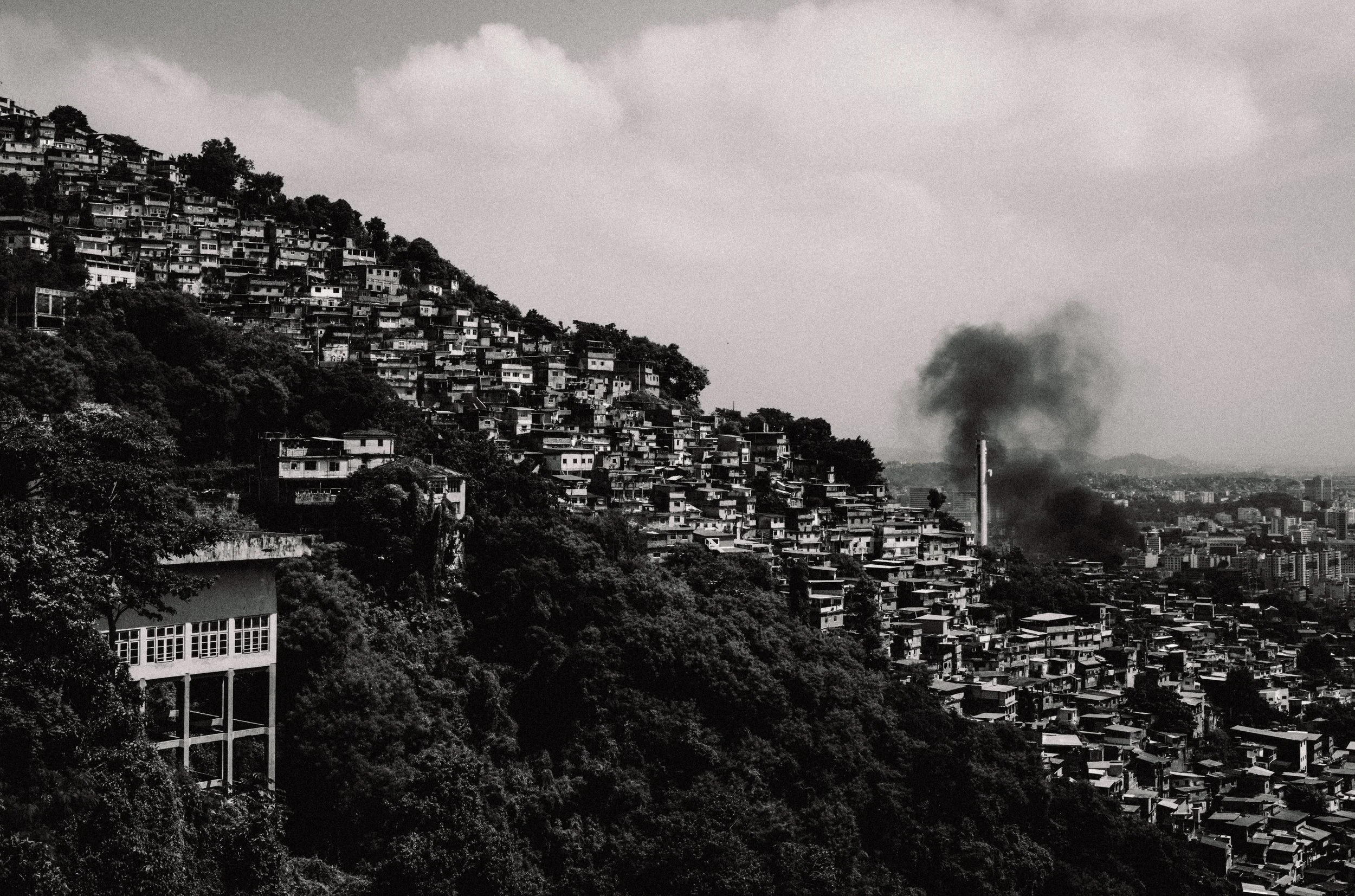  Smoke coming from a bus set on fire by CV members after a police operation that killed a high level boss. 