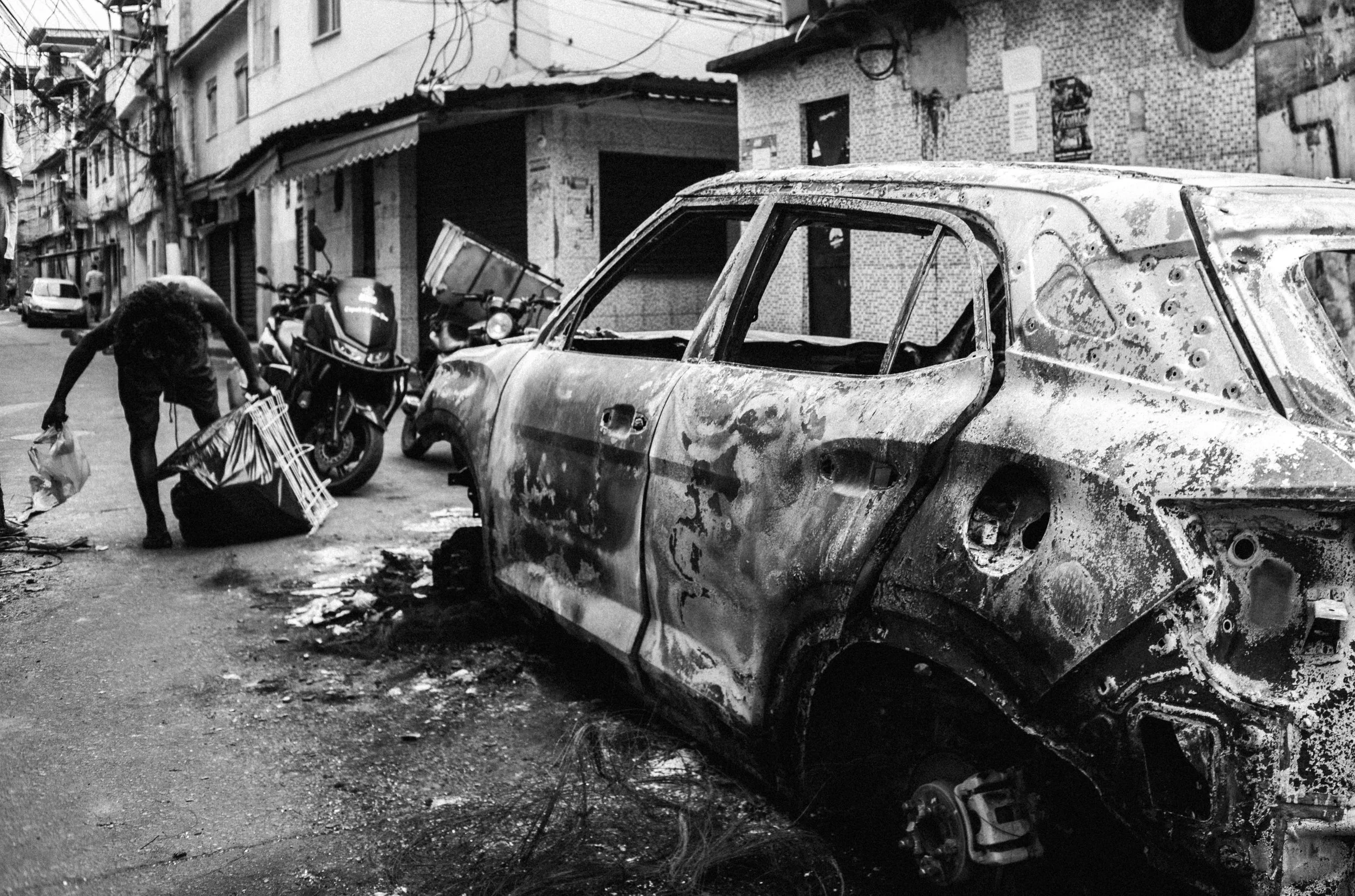  Car burned during a police raid in a favela controlled by CV. 