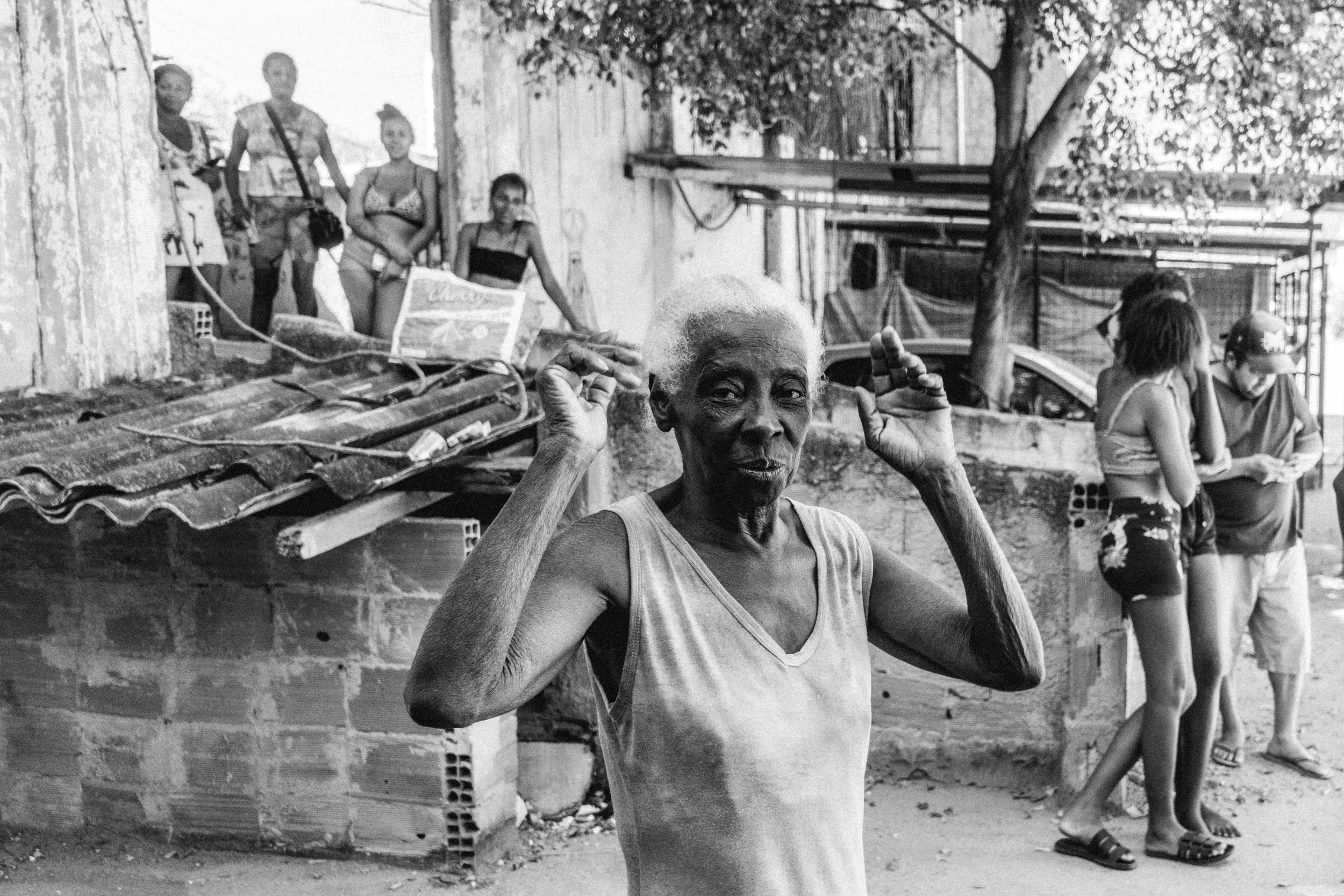  Dwellers of a favela called ‘Chupa Cabra’ gather outside during a hot summer day. 