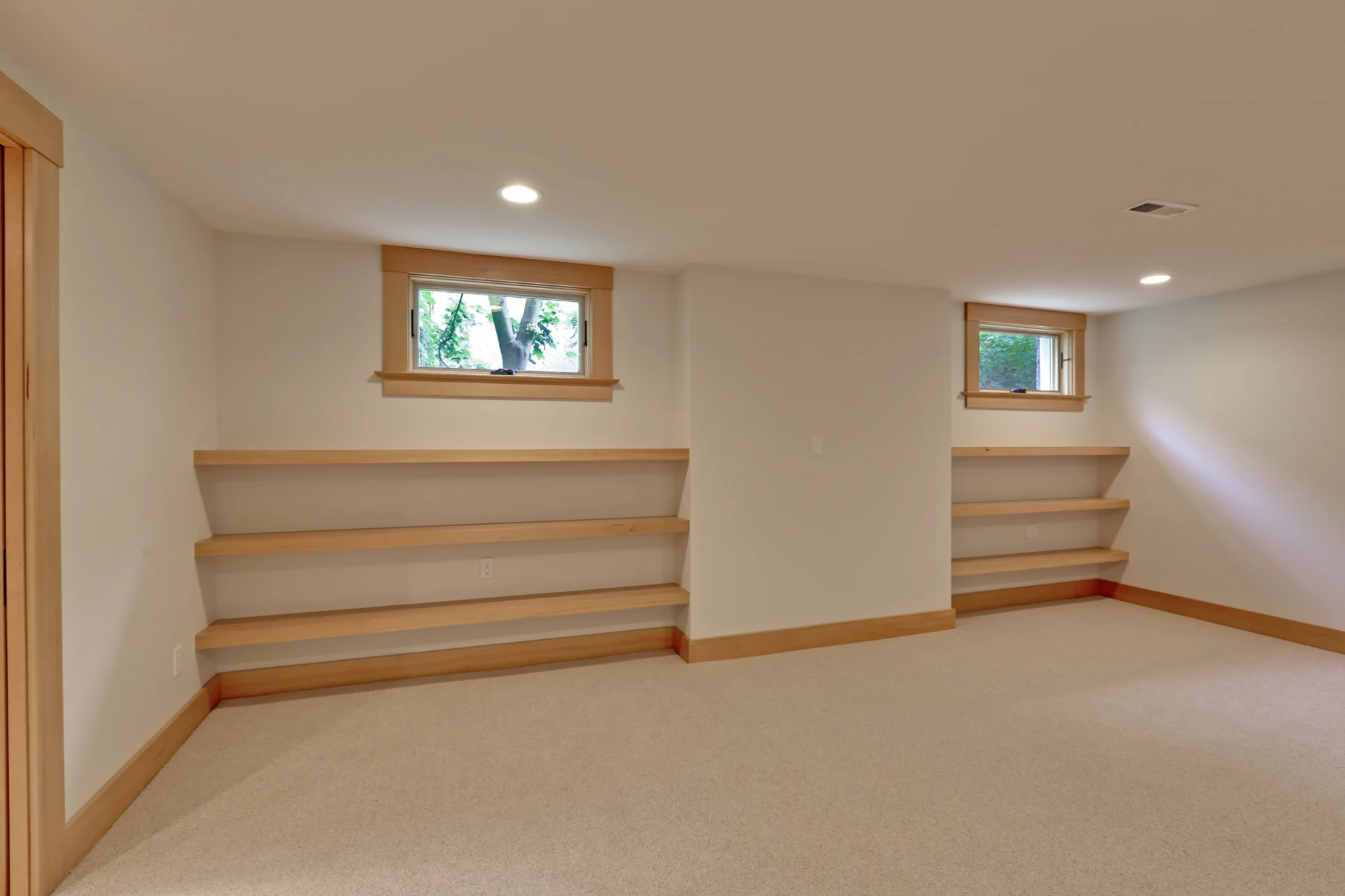 The basement family room was designed to add flexible and highly functional space to the house. The floating shelves will eventually house games, toys, and books for our clients' growing family.