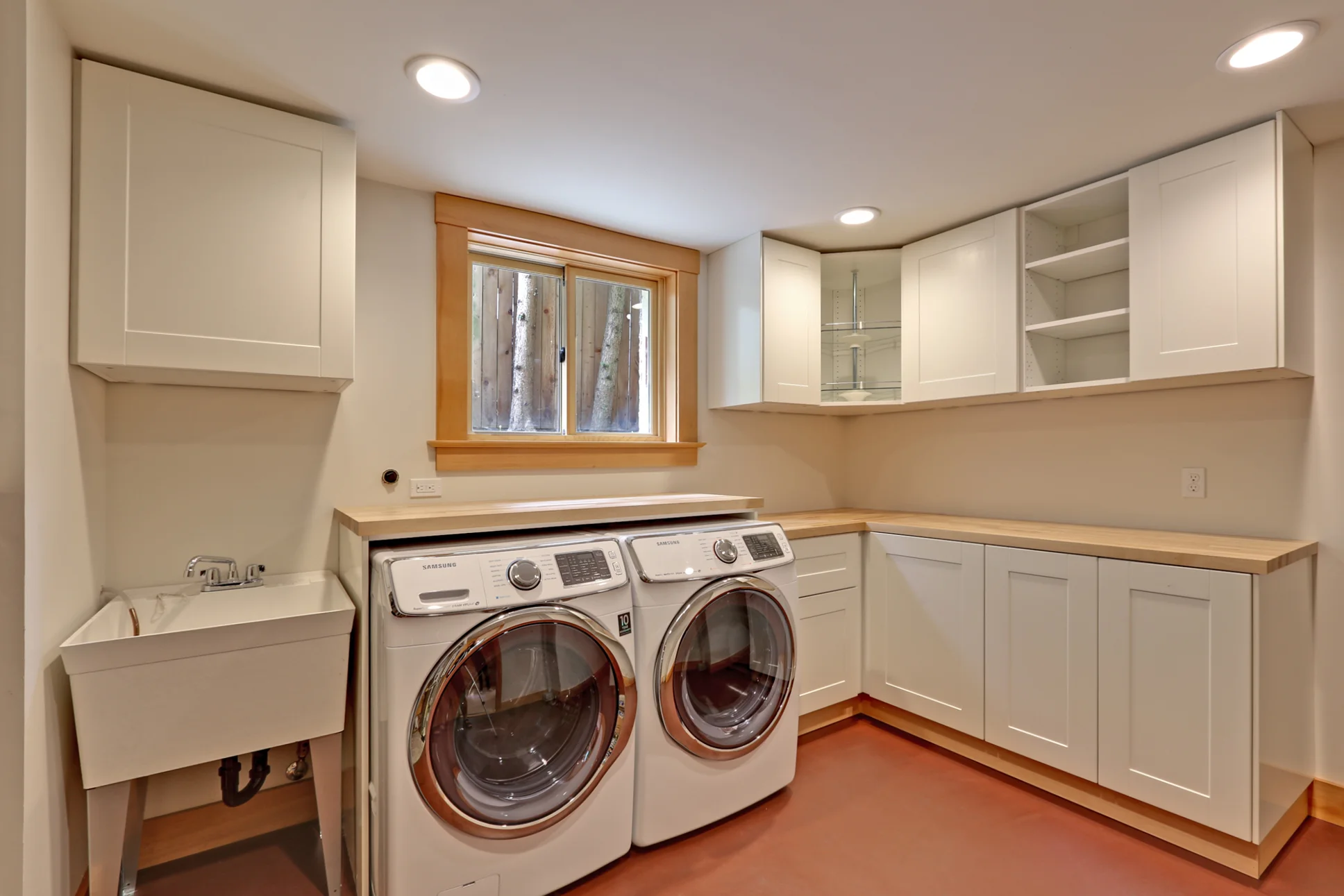 A modern take on the basement laundry room features Marmoleum flooring, new cabinets, and fresh paint, making this feel like a part of the home, rather than an afterthought.