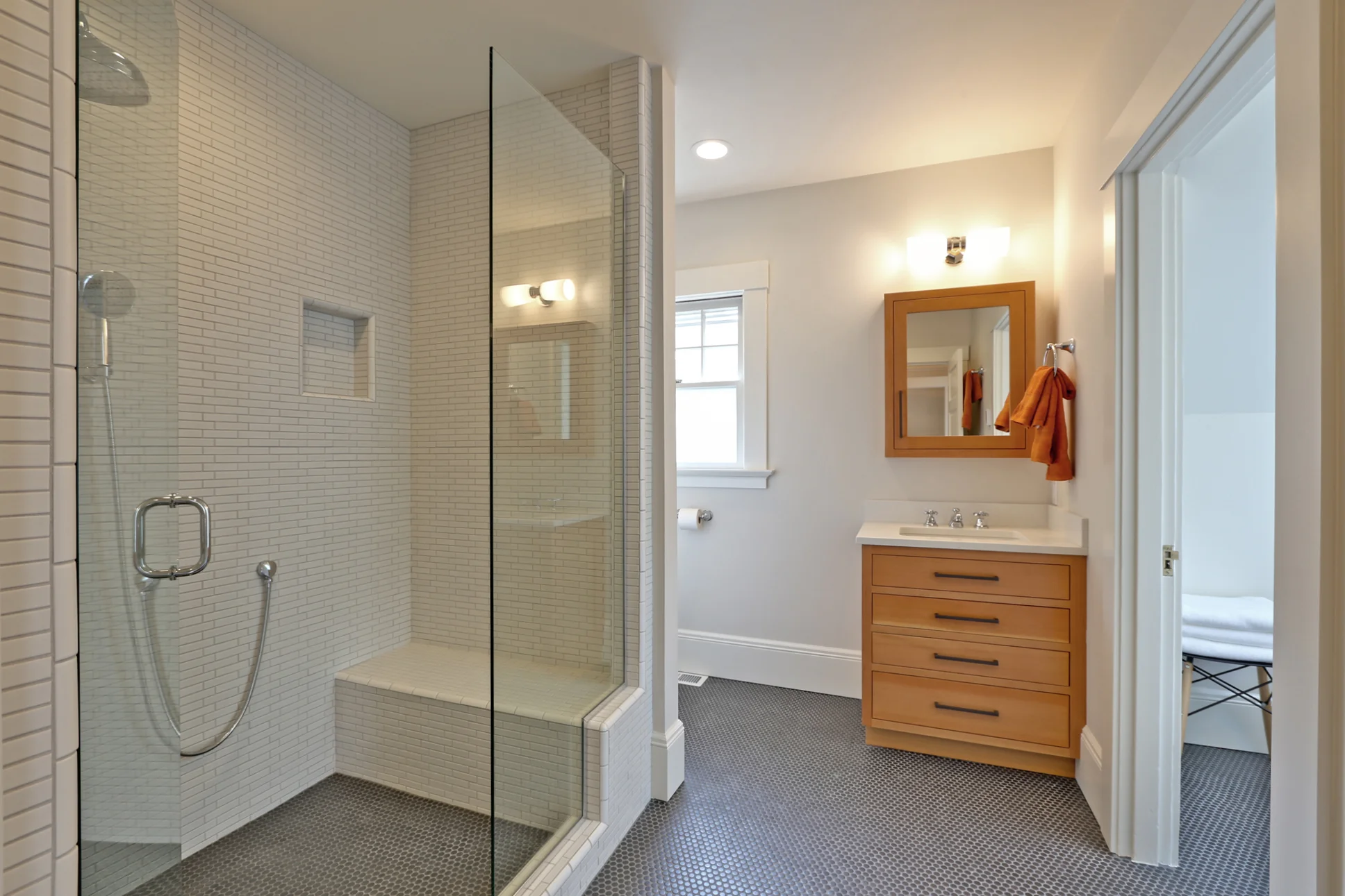 On the second floor, this newly reworked full bathroom features a massive shower with fantastic tile, a new custom Fir vanity, and a private tub room. We snuck some storage space under the sink with custom drawers cut around the plumbing fixtures. In the tub room the modern tub with CaeserStone deck tucks into the eaves of the house just perfectly, creating a private oasis for the homeowners.