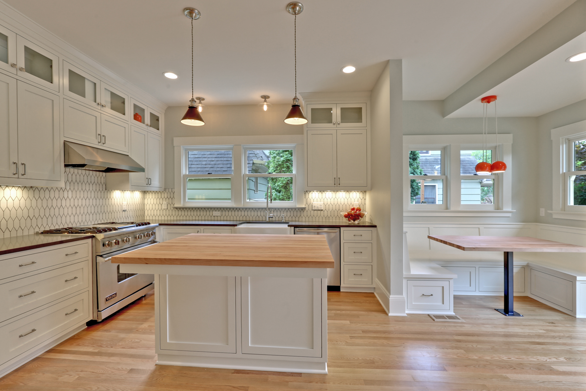  It's hard to remember what this kitchen looked like prior to our work; we removed walls, shifted appliances, and added a half-bathroom and breakfast nook. In addition, we installed all new plumbing, water heater, furnace, and electrical – all of whi