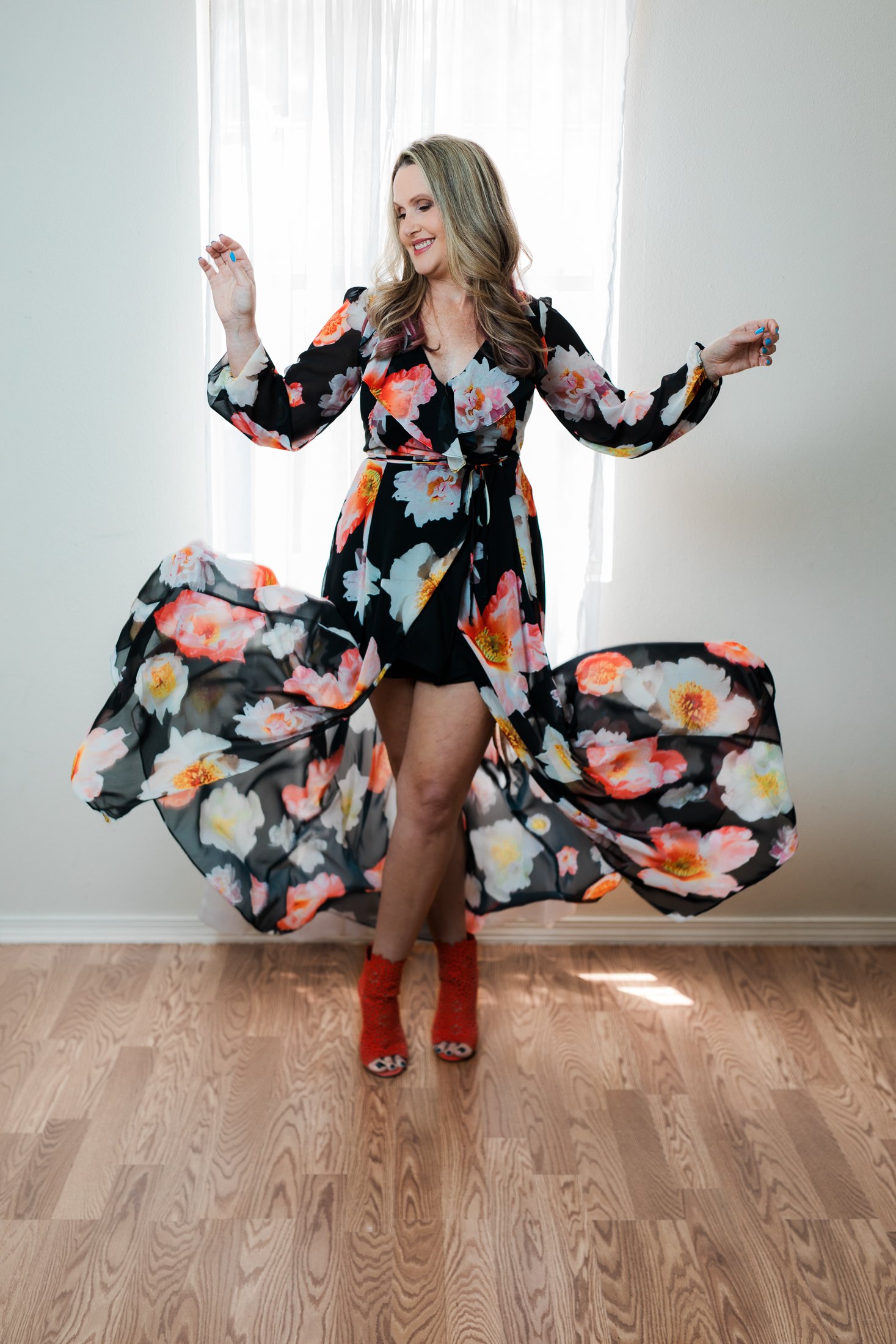 Jenna dancing in a navy floral dress in her 50 Over 50 Portrait Experience photo shoot with Amanda Faucett Photography