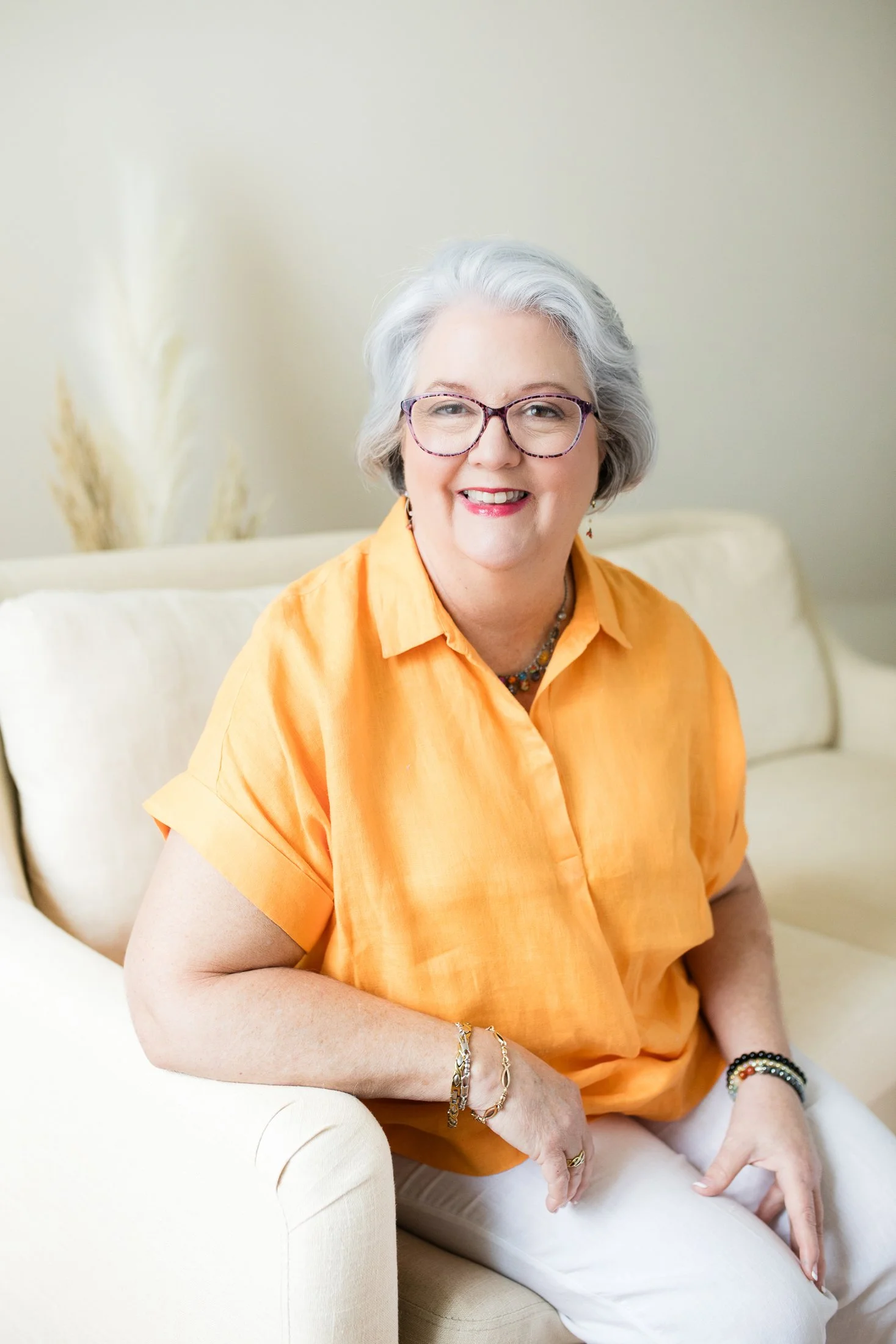 Judith seated in natural light during her 50 Over 50 portrait session in Houston.