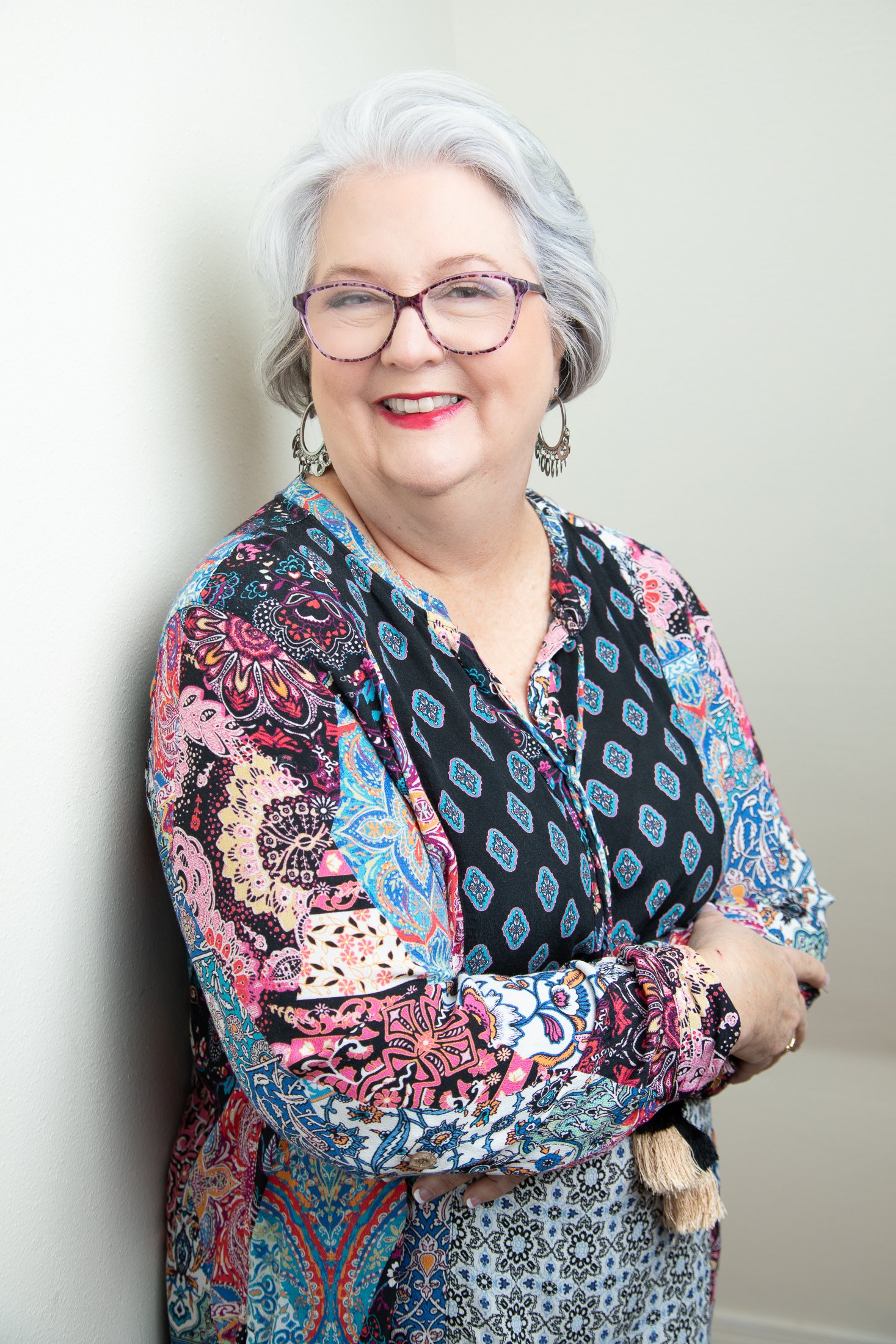 Judith casually leans against a wall in Amanda Faucett's northwest Houston during her 50 Over 50 studio photo shoot.