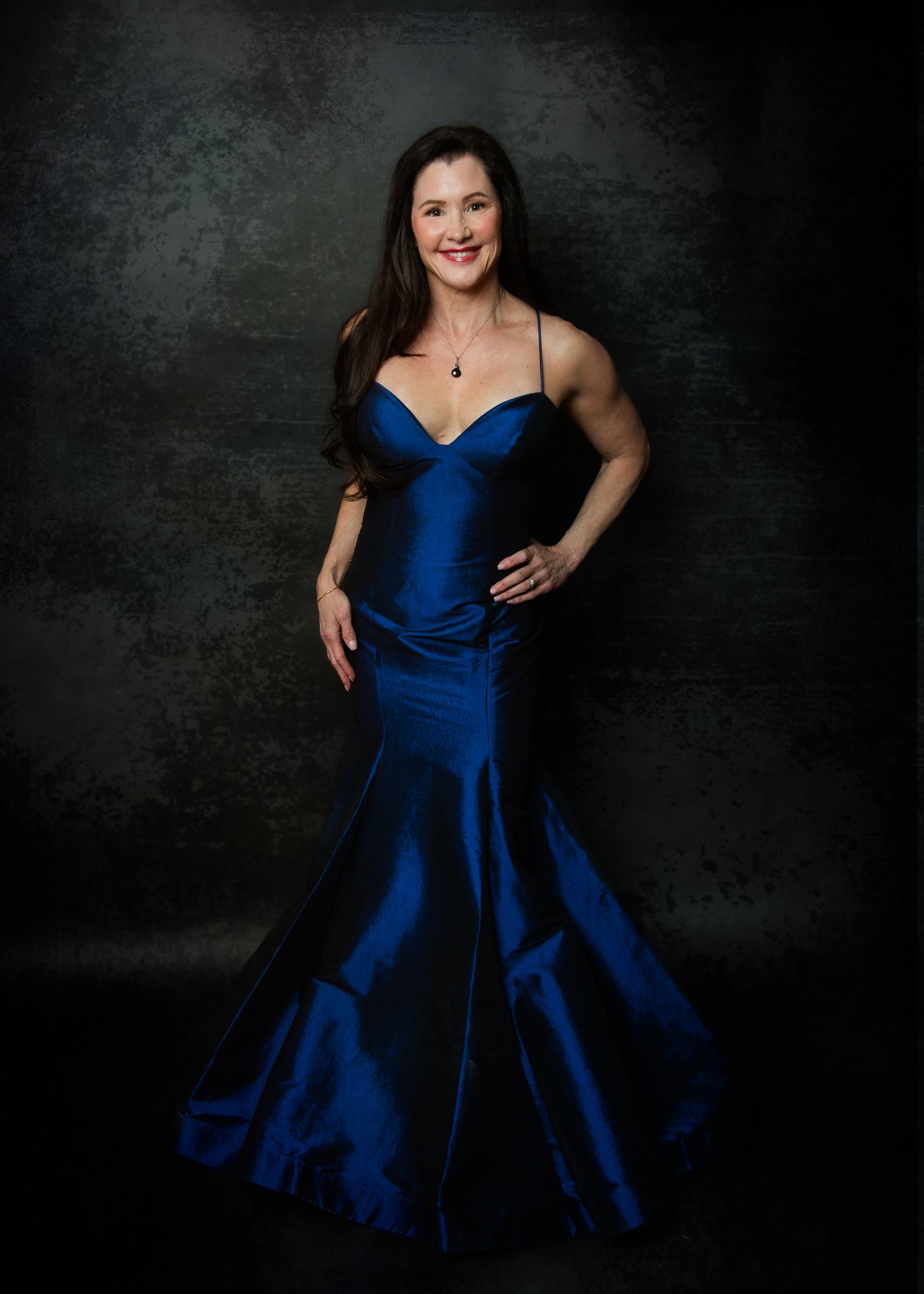 Full-body portrait of Michelle wearing a mermaid-style full-length gown, celebrating life after 50 through professional portrait photography.