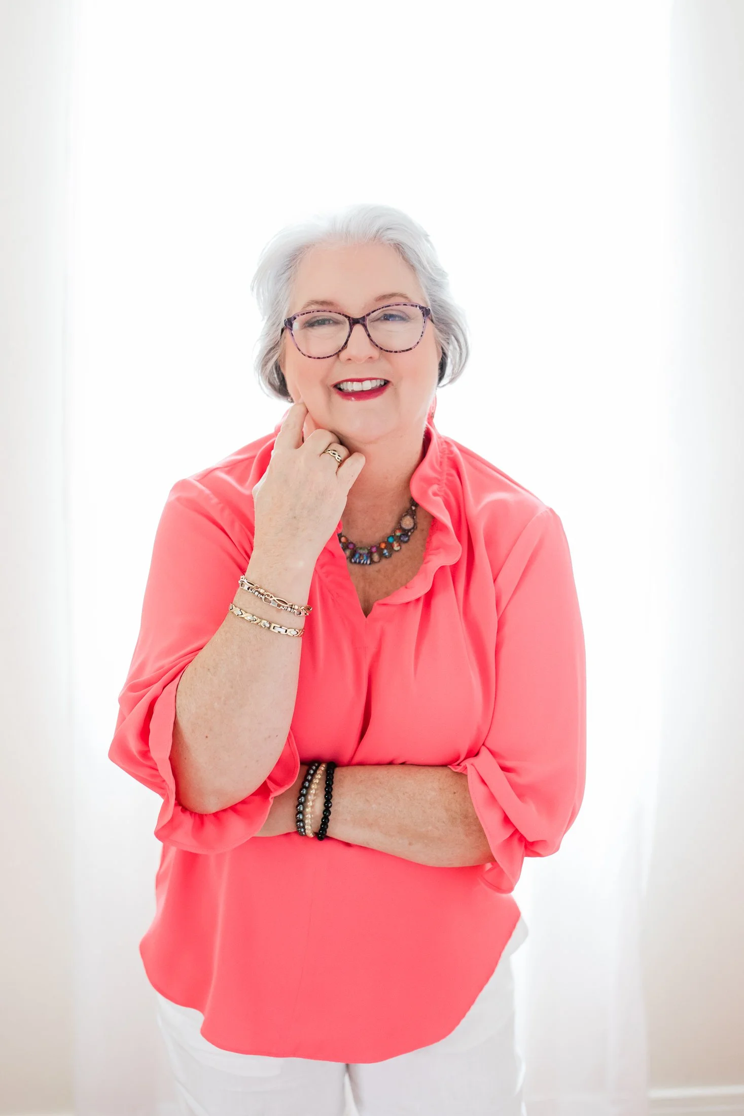Timeless backlit studio portrait of Judith, celebrating beauty and confidence after 50.