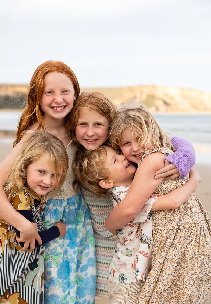 Cousins cuddling on the beach