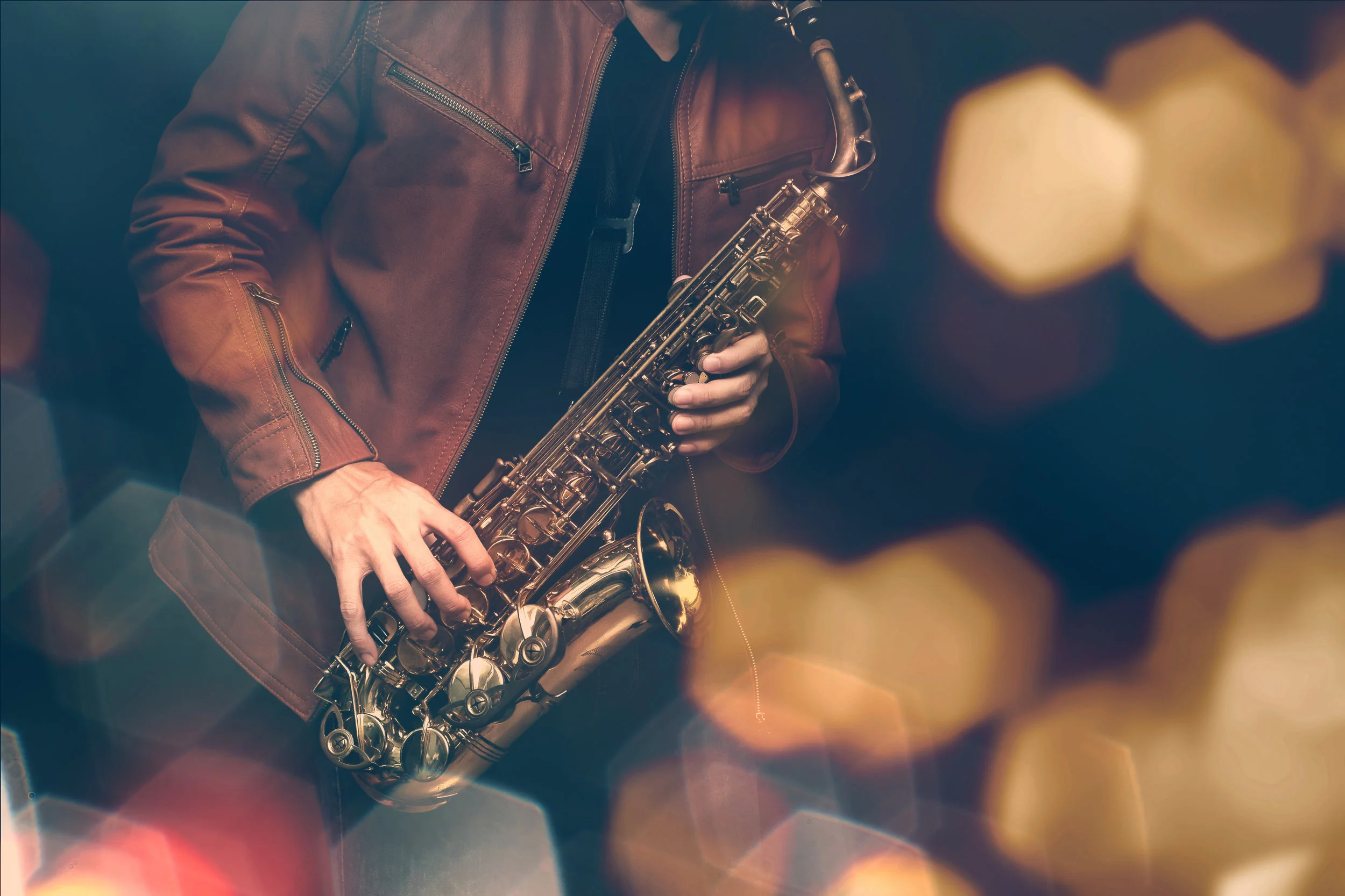 Jazz saxophone player in performance on the stage. color filter and hexagon bokeh added.