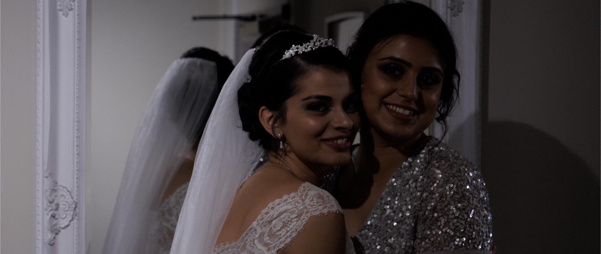 Bride and sister smile at Indian wedding.jpg