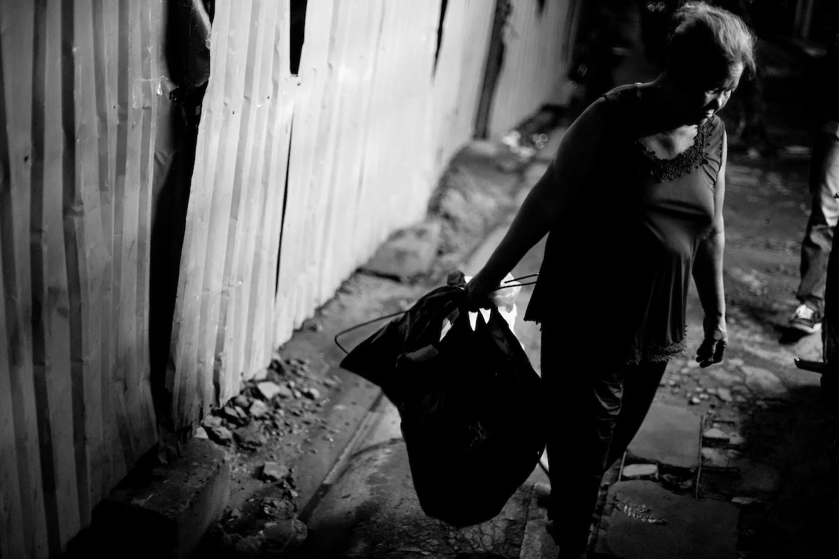Hoang Thi Dao, 65 years old, Ho Chi Minh City, Vietnam. Dao earns her living since more than 20 years by picking through the garbage in the cities Go Vap district and selling everything that is possible to recycle. With this she makes around 20.000 VND (around 1 USD) per night. She takes care of her two granddaughters Truc and Cuc (12 years old).