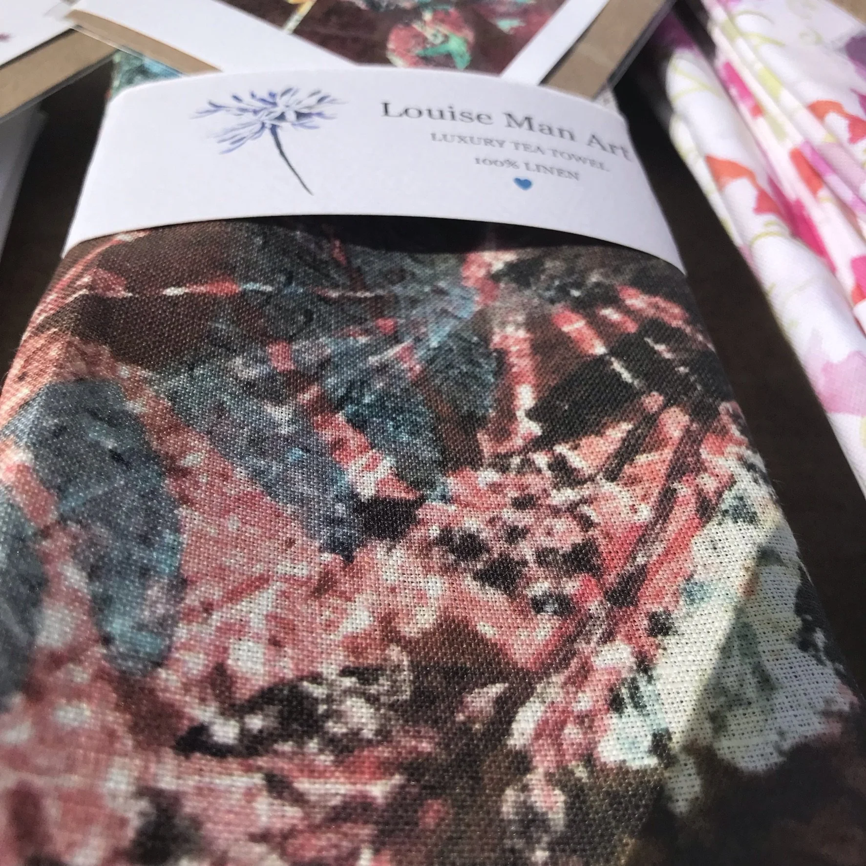 Tea towel with autumn colours of pinks and browns