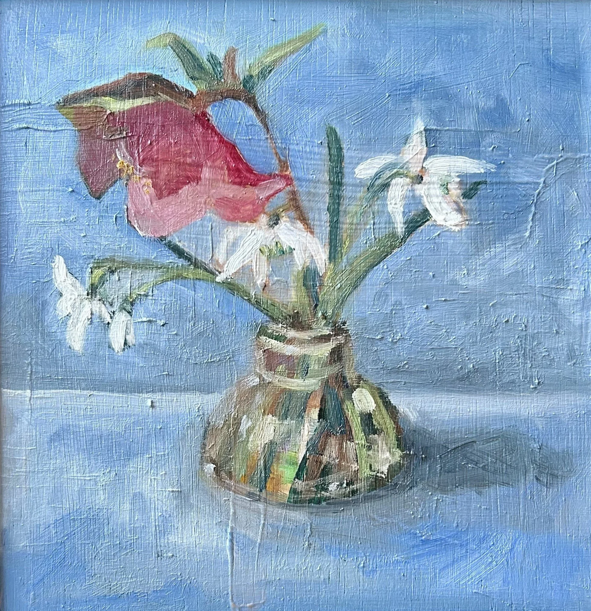 snowdrops and hellebore in a glass vase