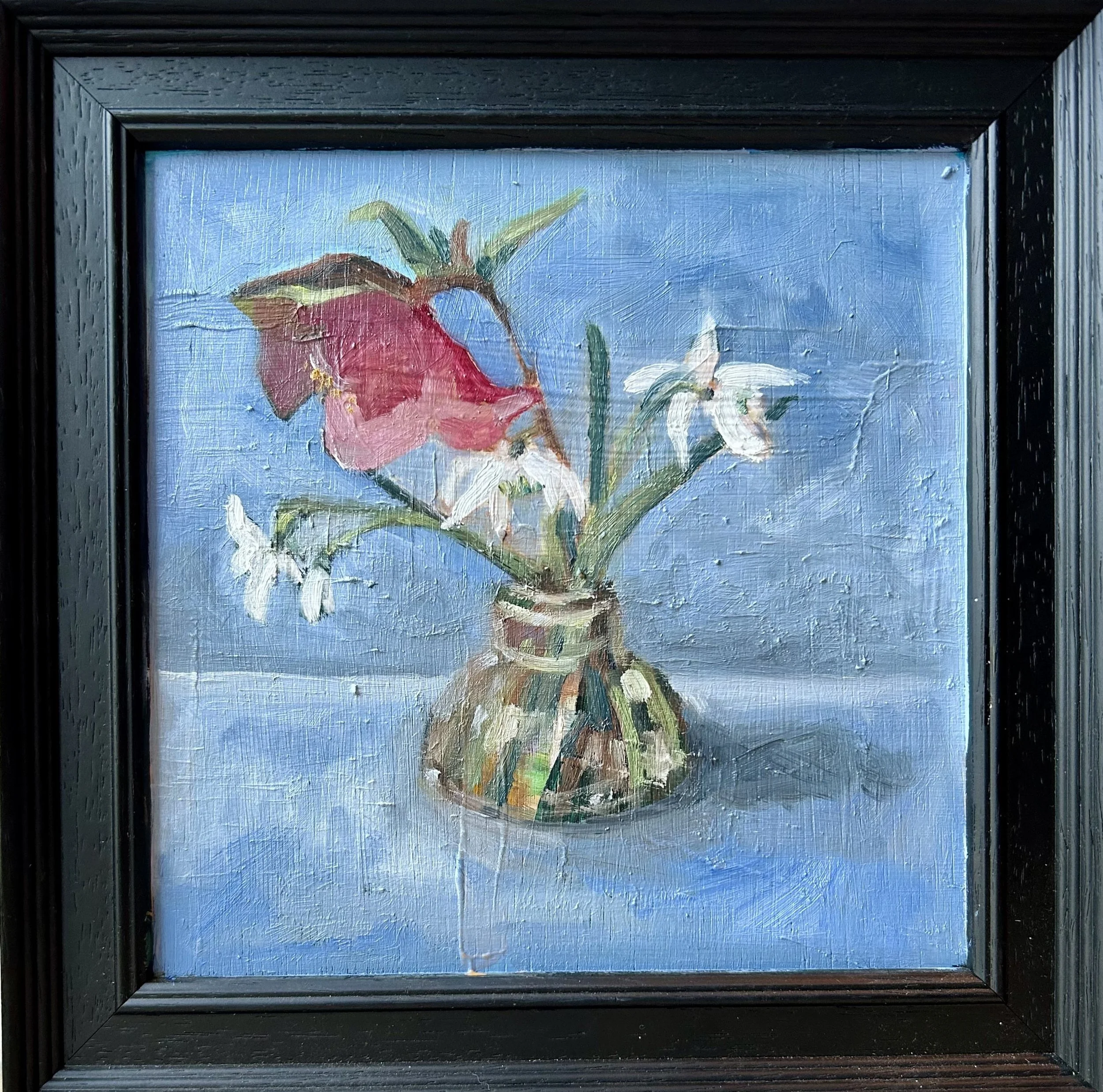 snowdrops and hellebore in a glass vase