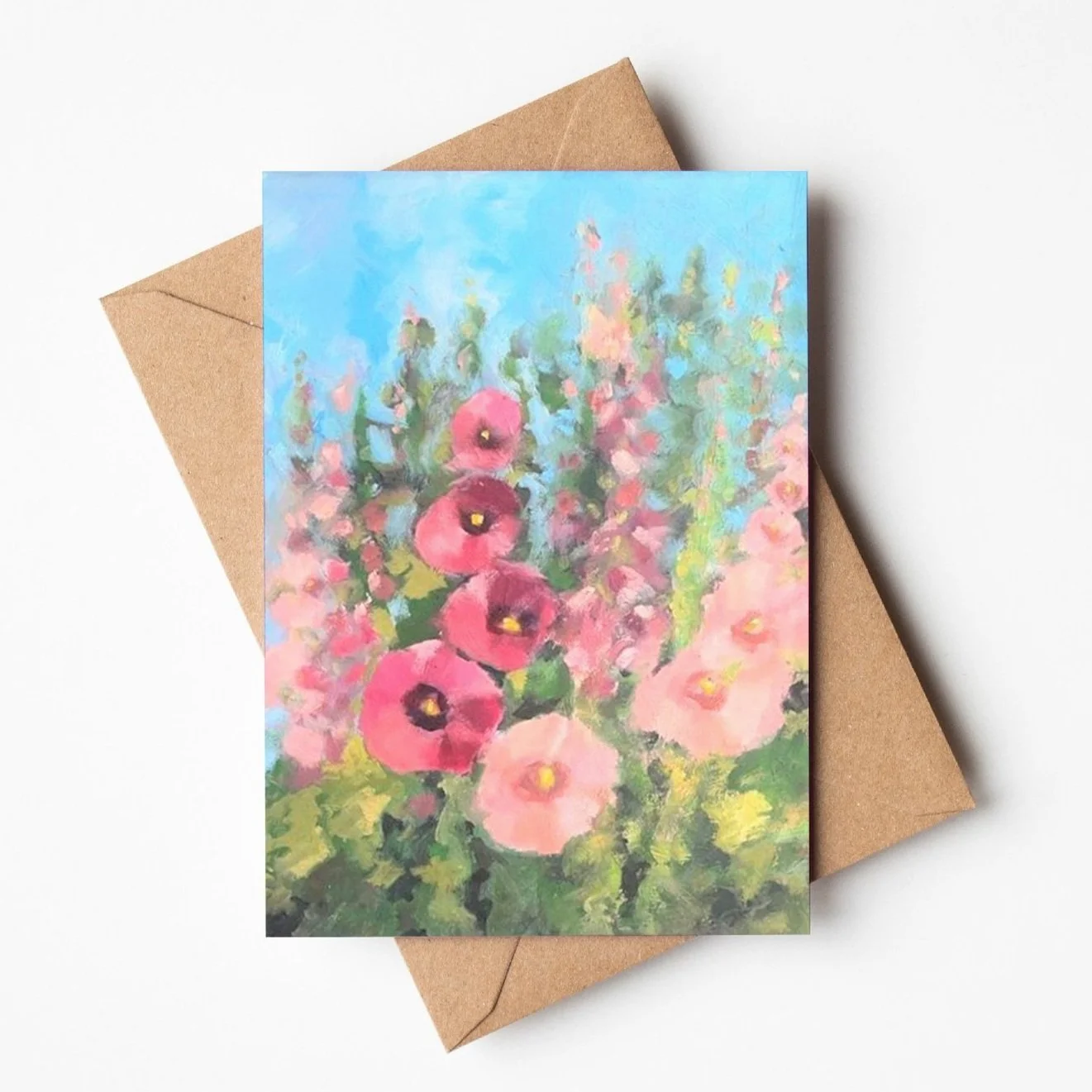Hollyhocks growing in the garden greetings card by Louise Man