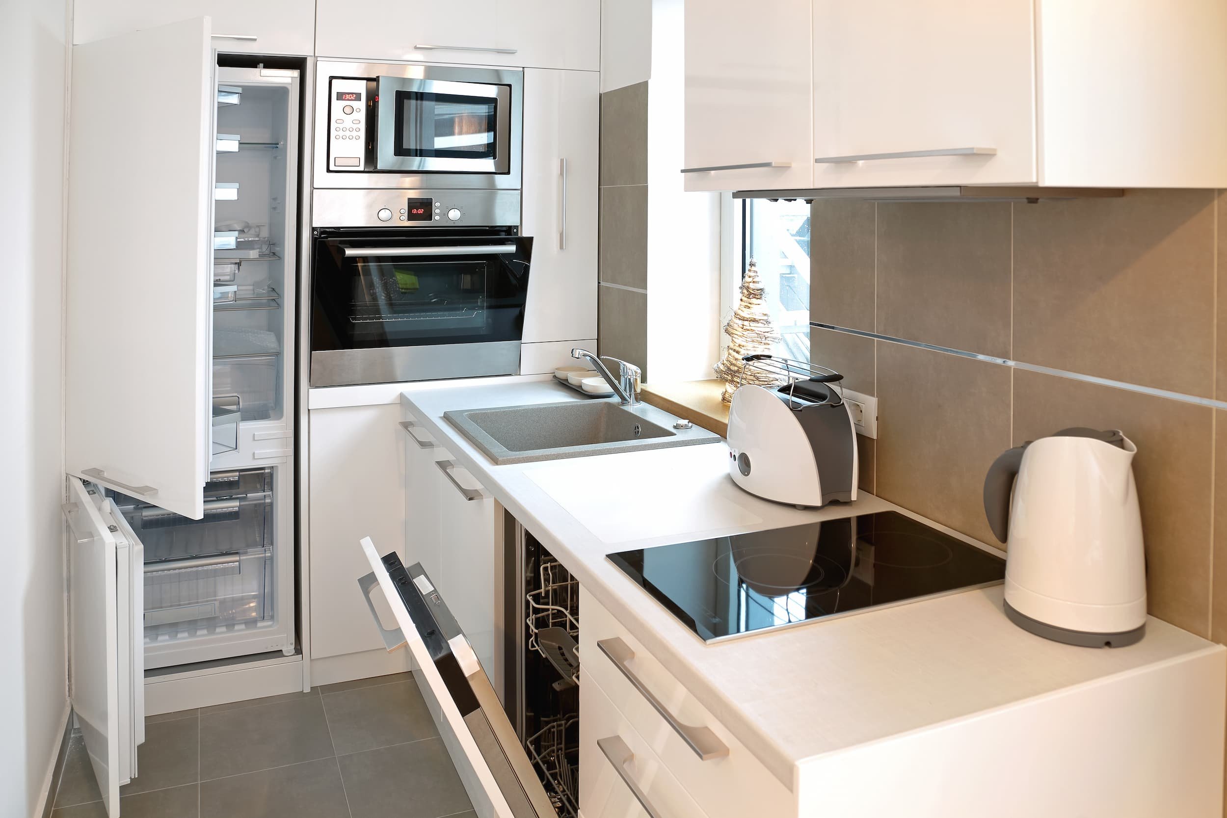 A small, compact kitchen, with minimal counter space and plenty of bespoke storage.