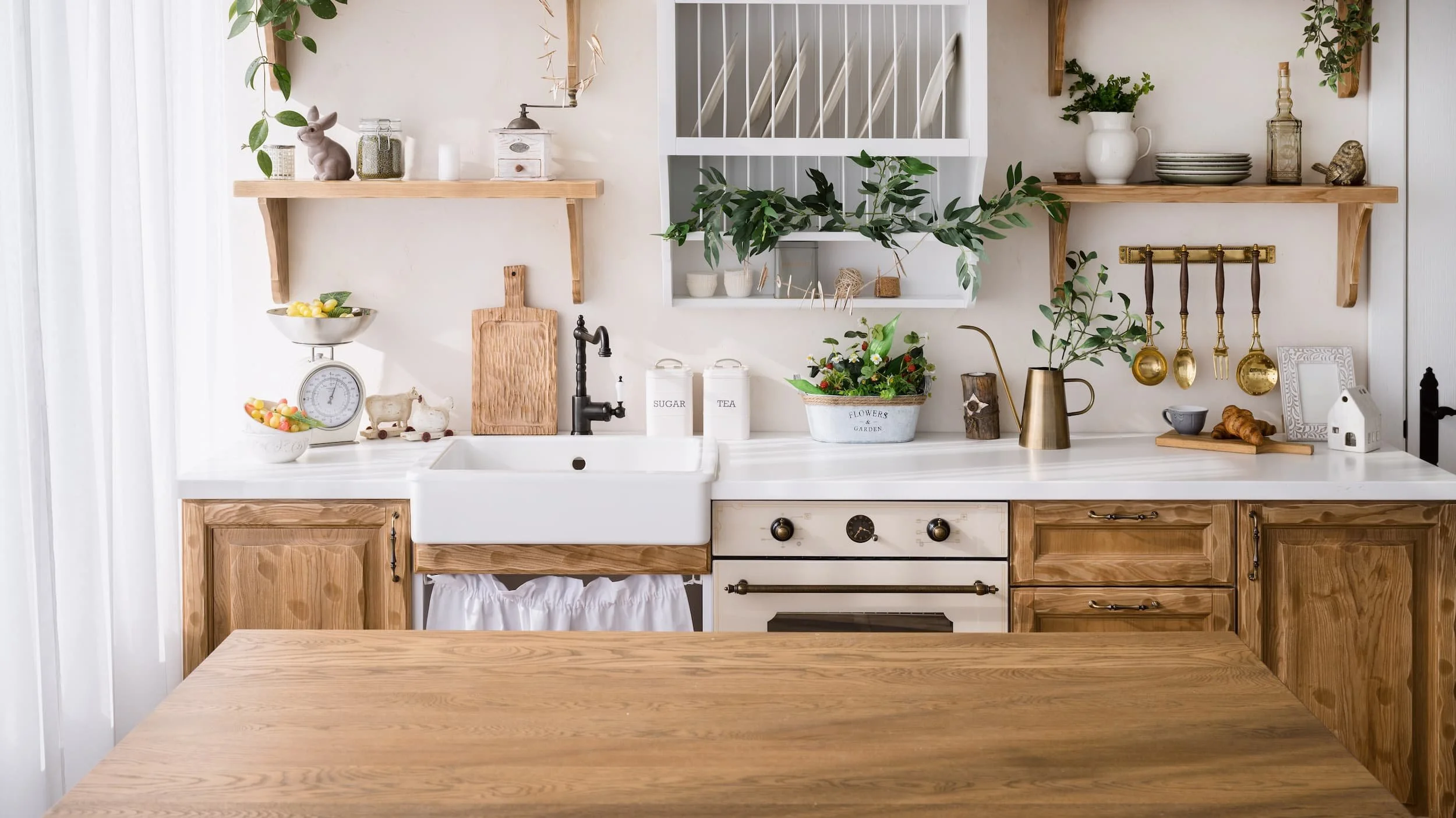 A light, airy farmhouse-style kitchen with natural wood and marble countertops.