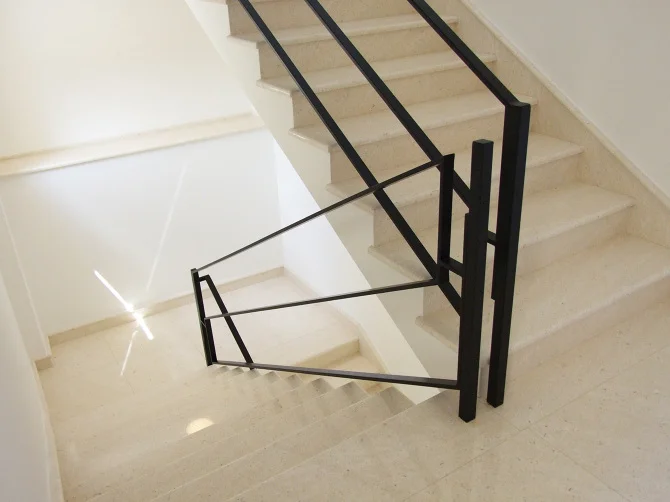 Side view of the installation, emphasizing the rigid steel construction and its function as a secure architectural barrier.