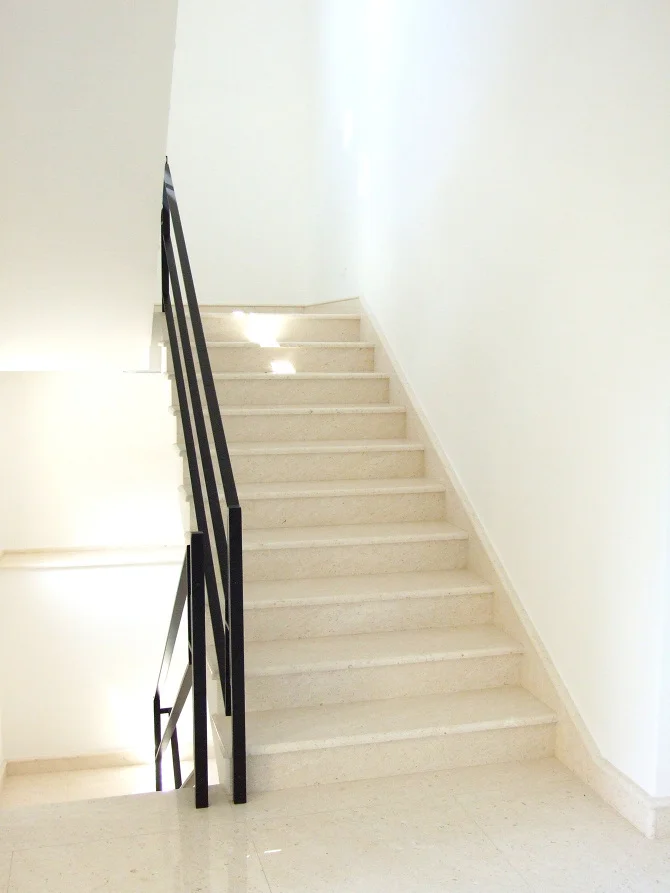 Side view of the installation, emphasizing the rigid steel construction and its function as a secure architectural barrier.