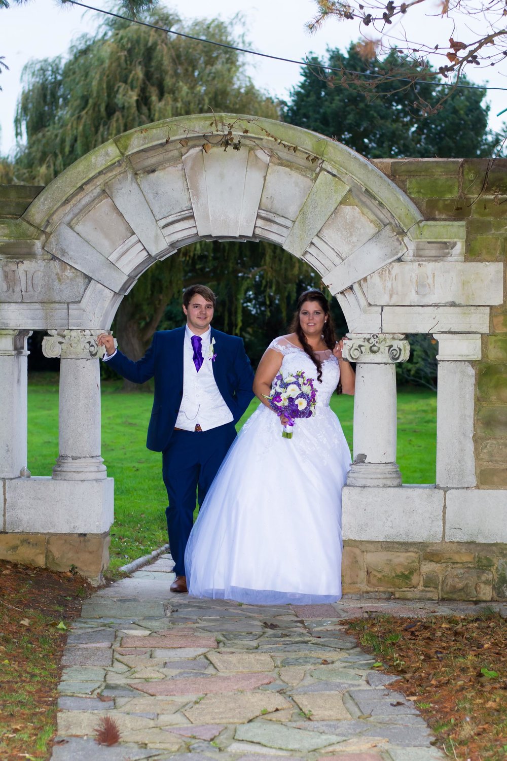 Ye Olde Plough House with bride and groom under one of the arches