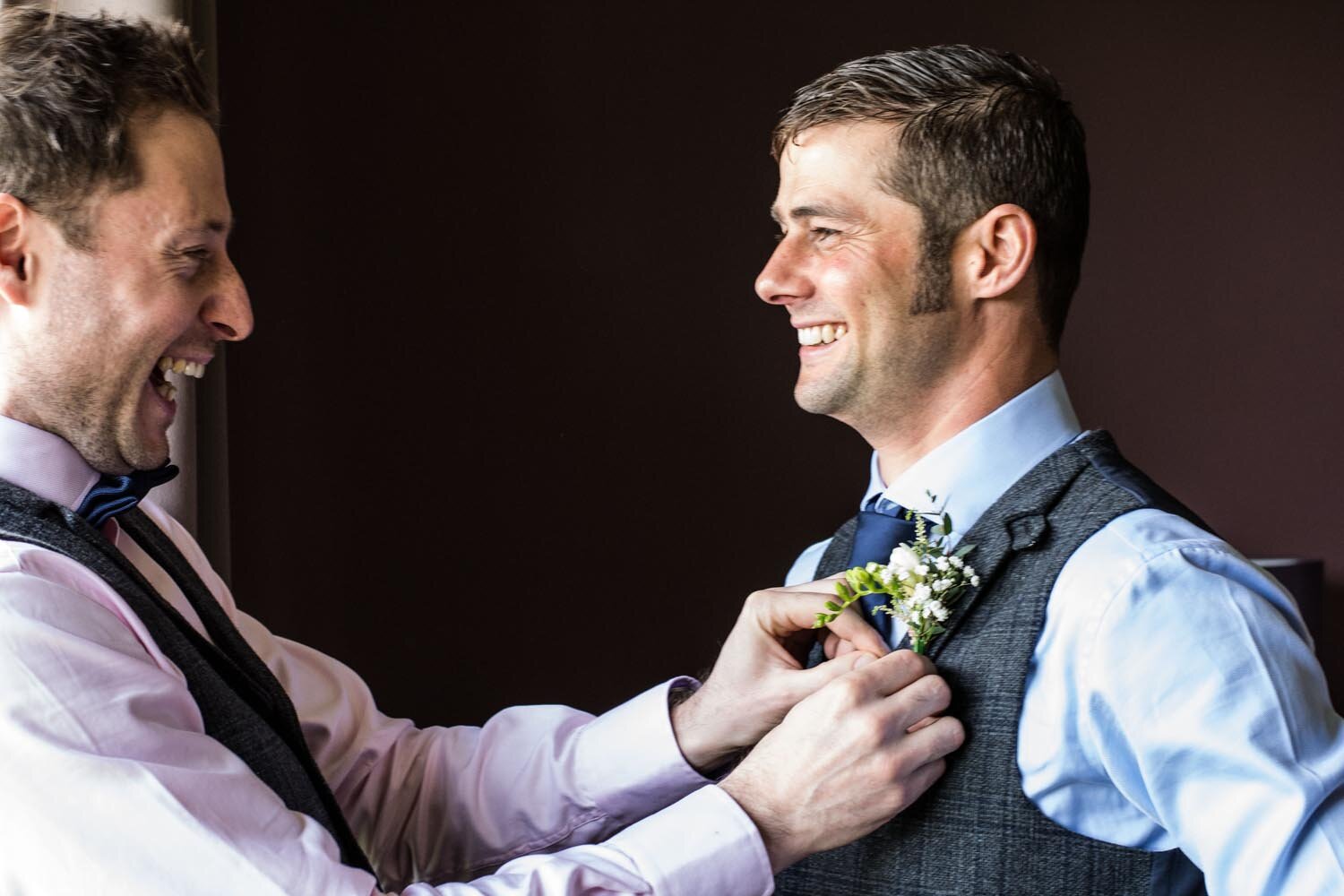 groom and best man adjusting tie