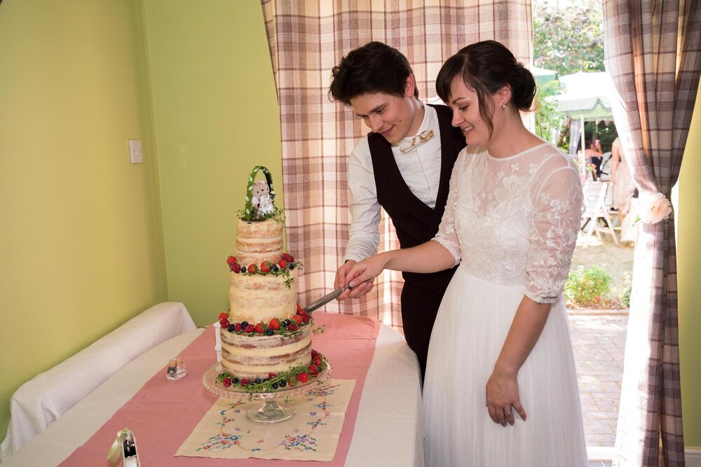815-cutting-cake-Cressing-Temple-Barns-Wedding-Photography.jpg