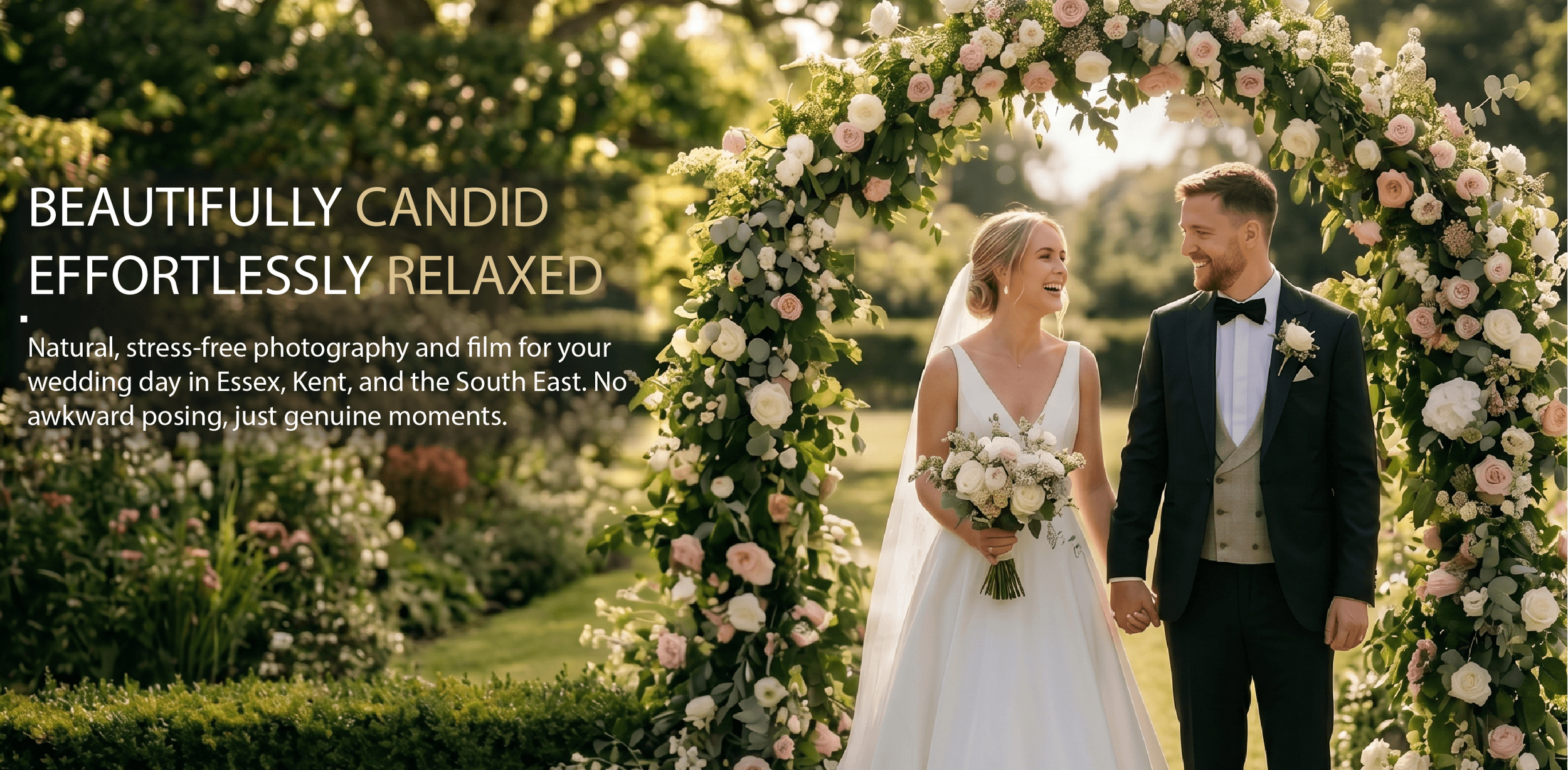 bride and groom under a flower arch