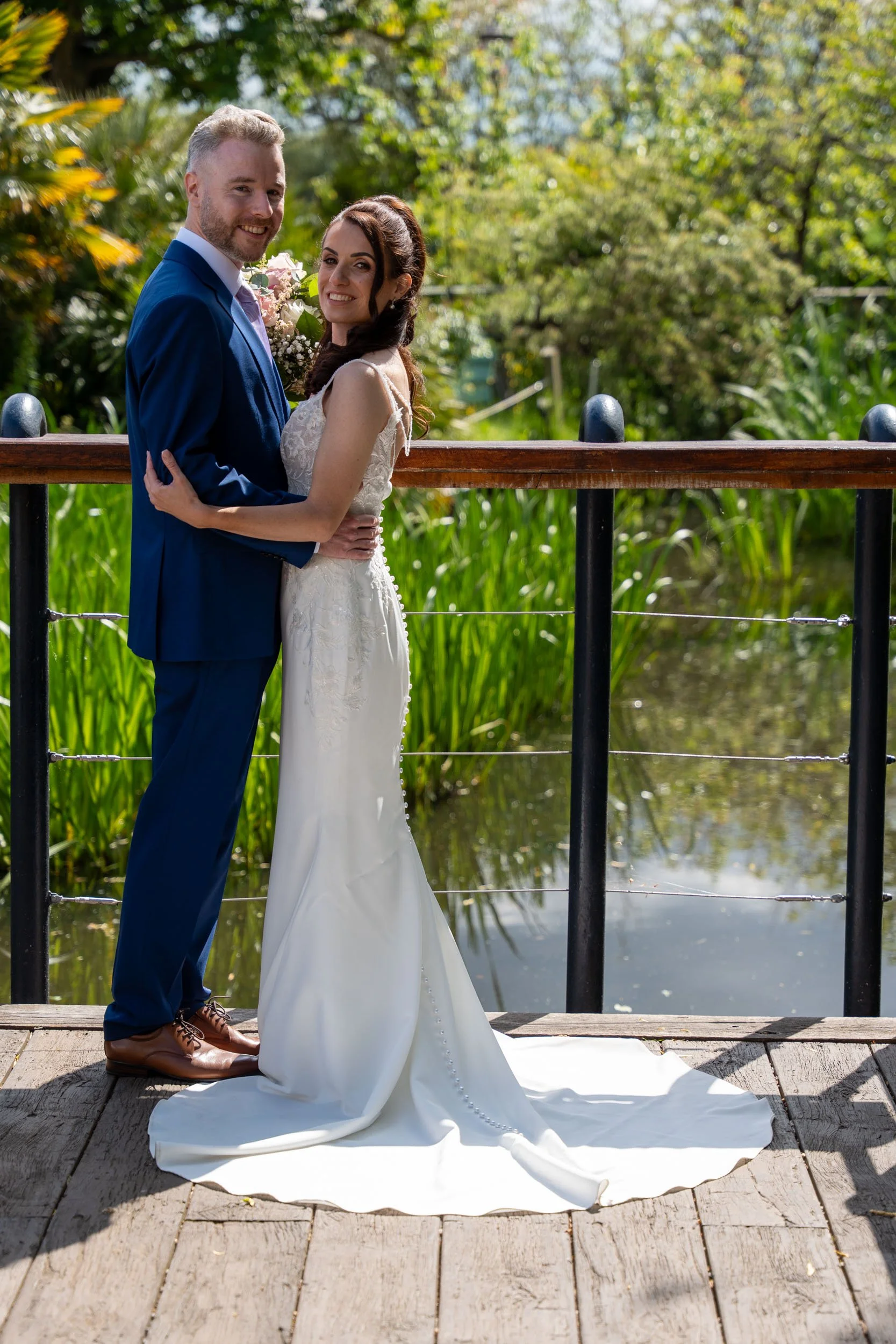 Liam & Lauren Friern Manor wedding posing on the deck with big smiles